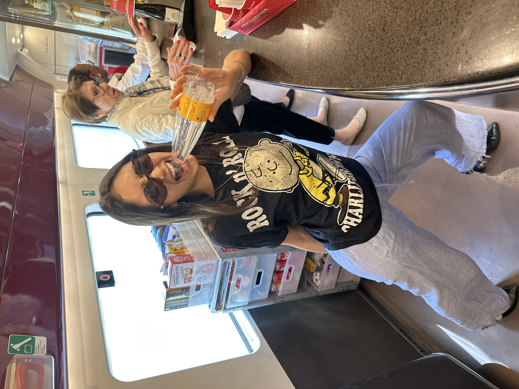 Woman drinks water on train in Barnay, France