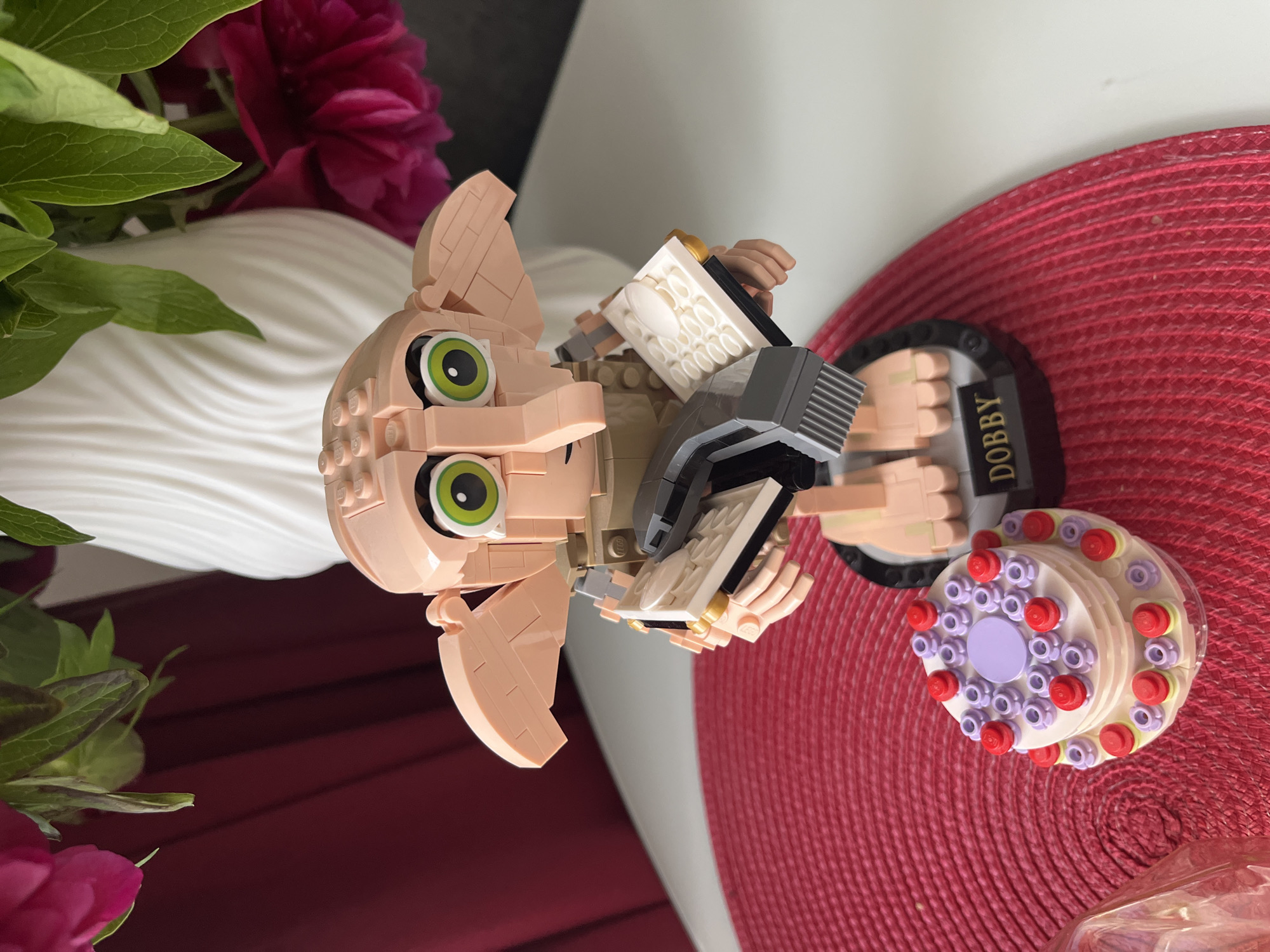 LEGO Dobby figurine photographed with flowers in Shushary, Russia