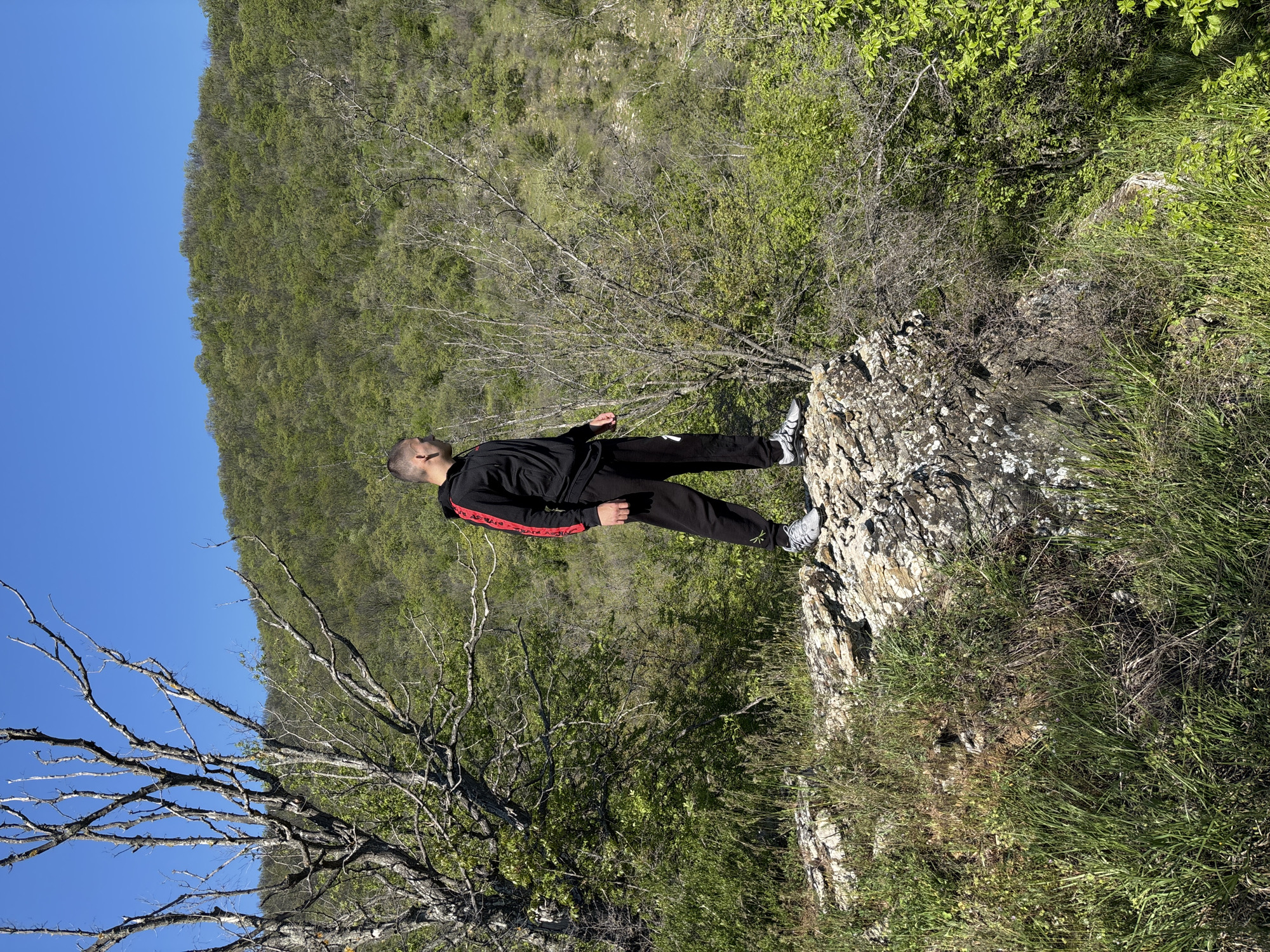 Man poses at scenic overlook in Goritsa, Bulgaria