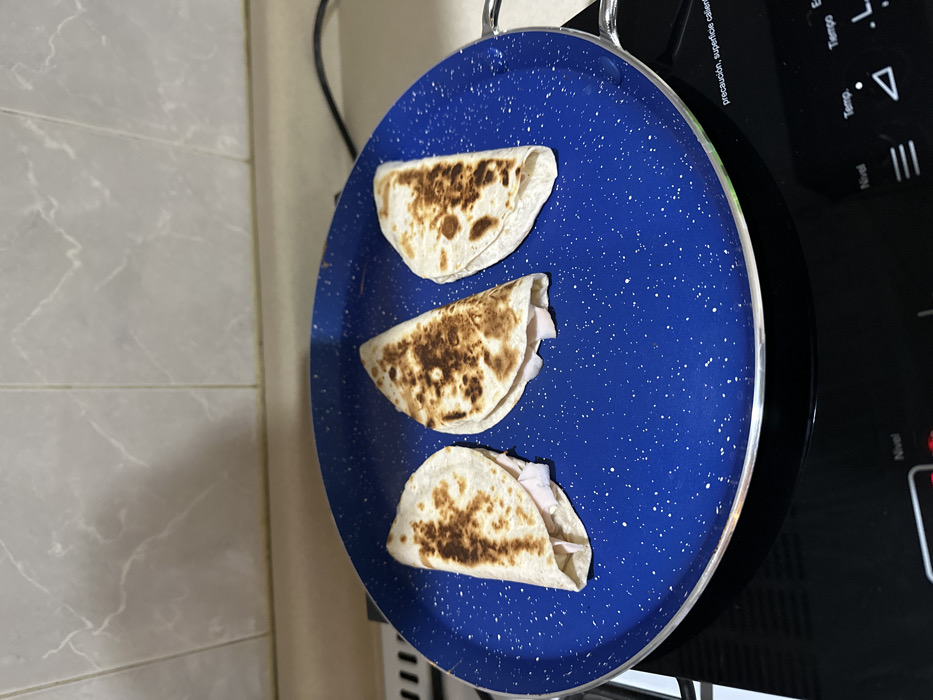 Late-night quesadilla preparation captured in Puebla kitchen