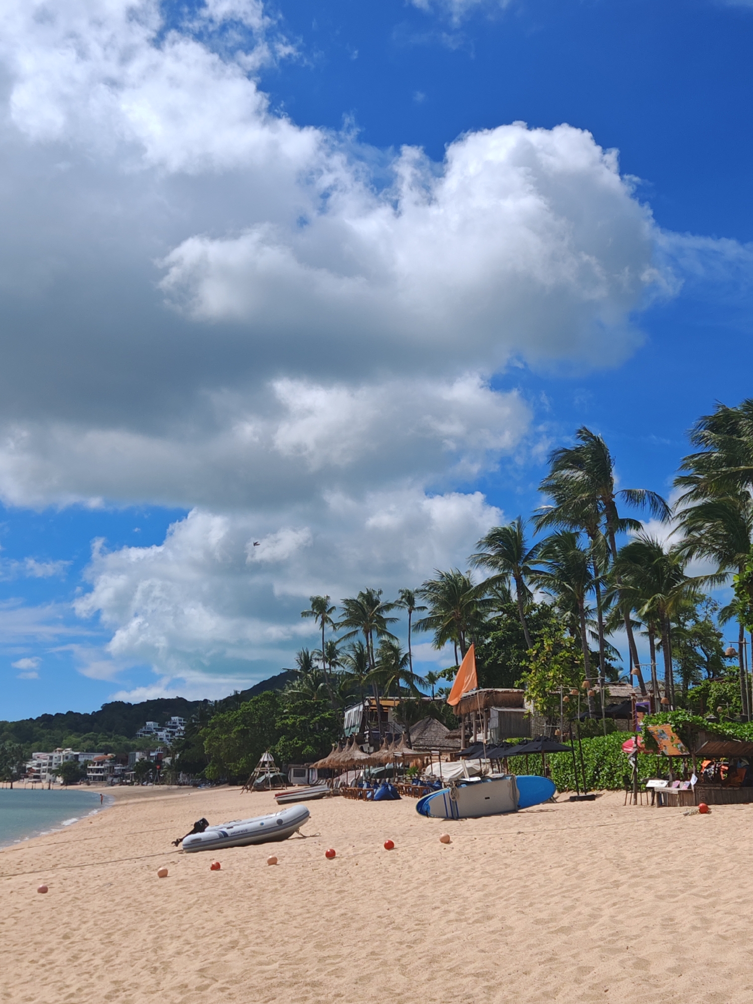 Sunny afternoon at Bo Phut beach, sailboats anchored offshore