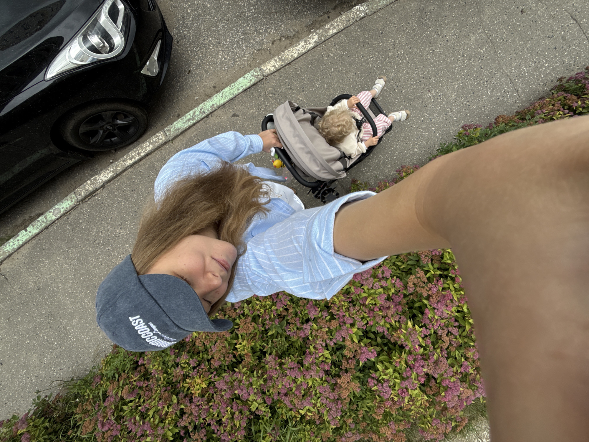 Stroller outing on a Vladimir sidewalk, summer morning