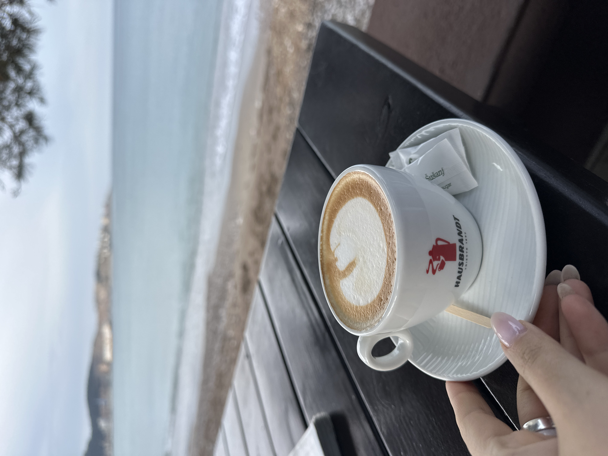 Morning cappuccino enjoyed at beachside cafe in Šušanj, Montenegro