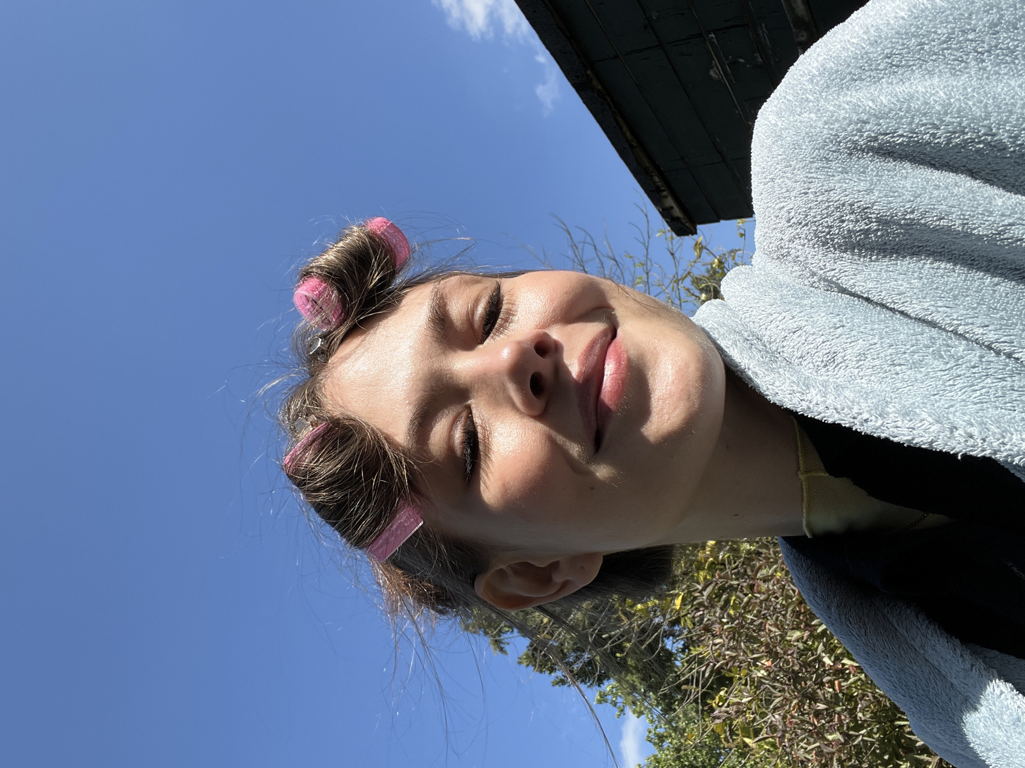 Young person in curlers photographed in London morning routine
