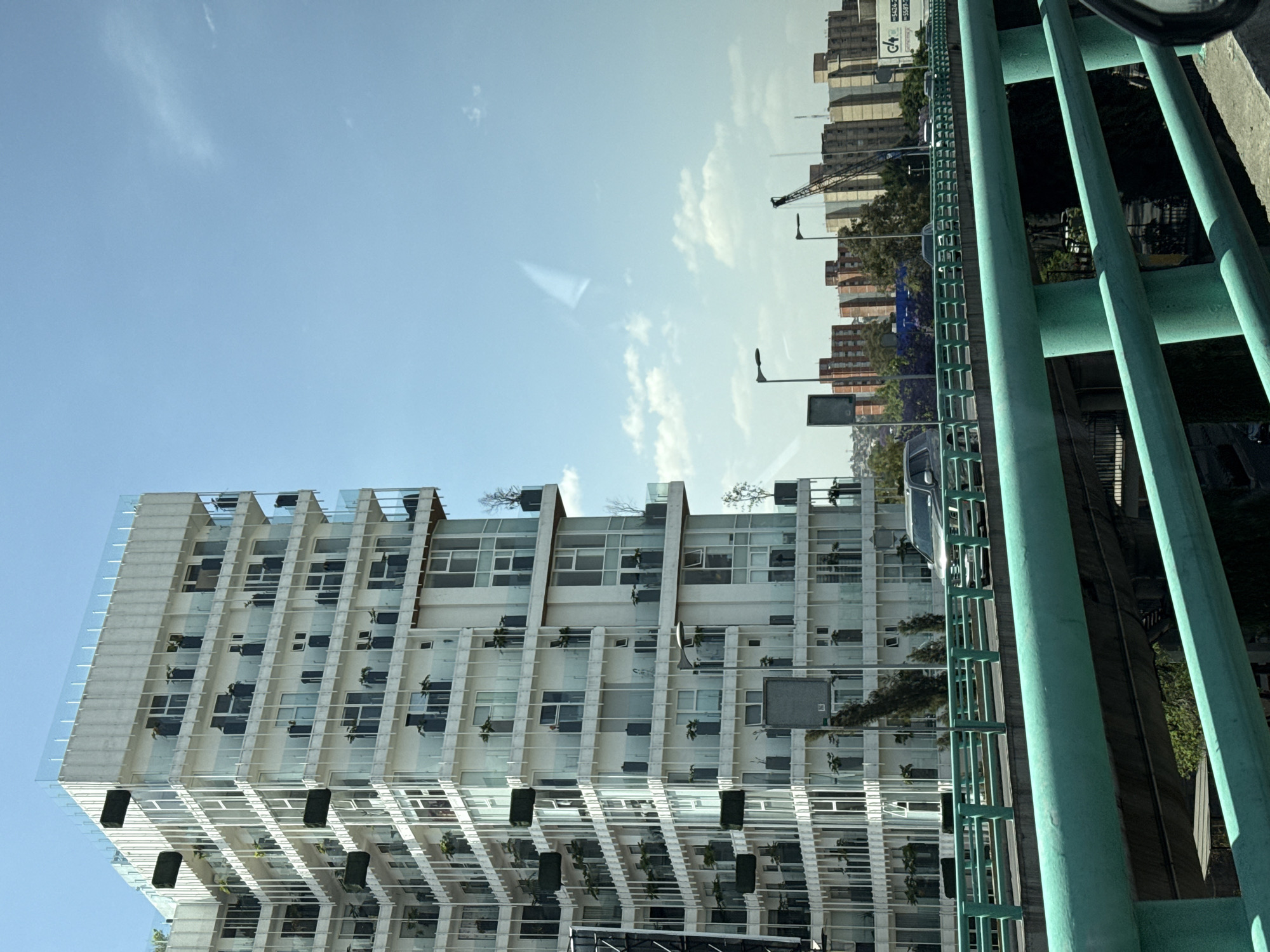 Vehicle travels elevated highway in Mexico City showing urban skyline