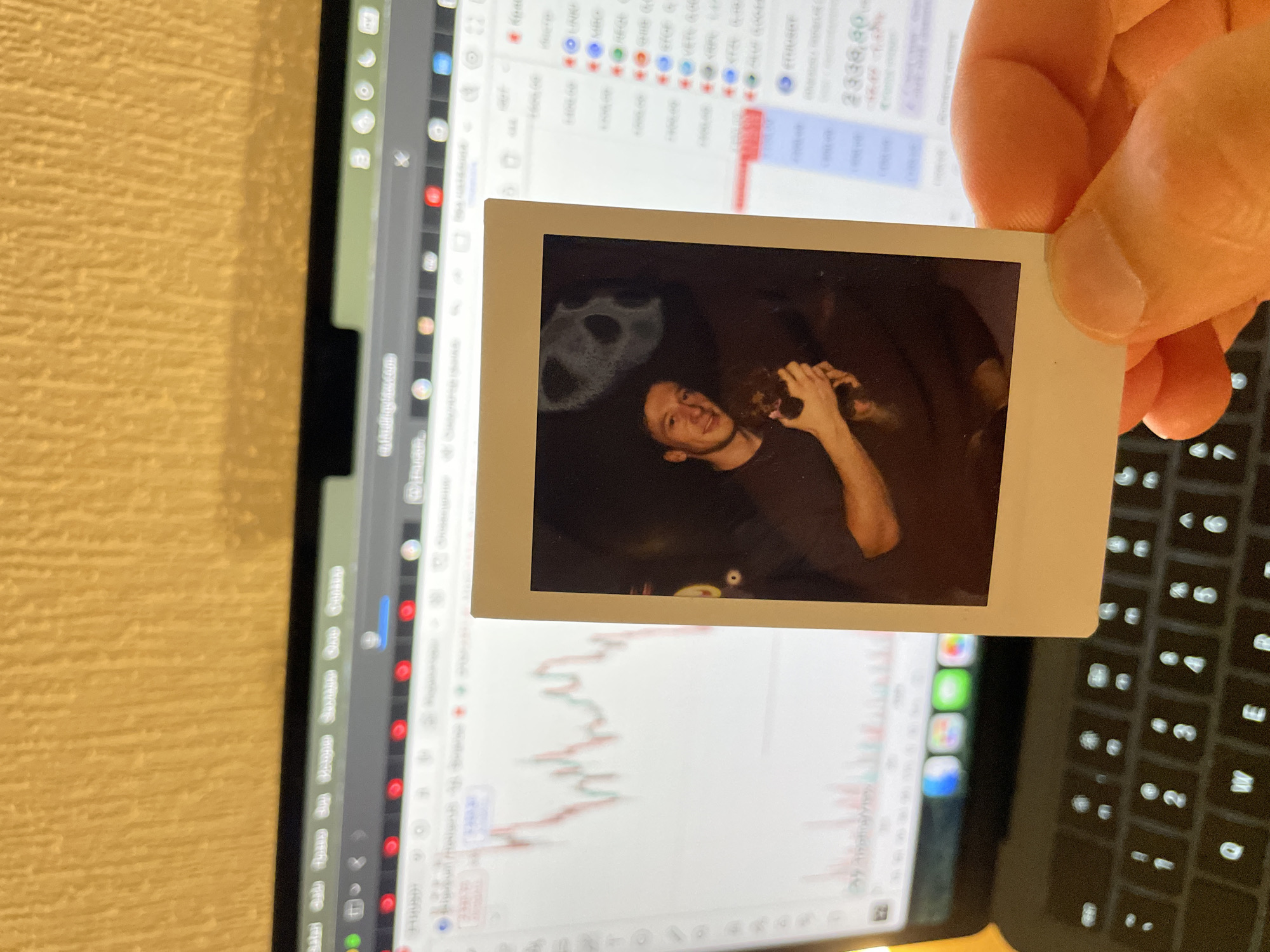 Person holds vintage photo over laptop in Russia
