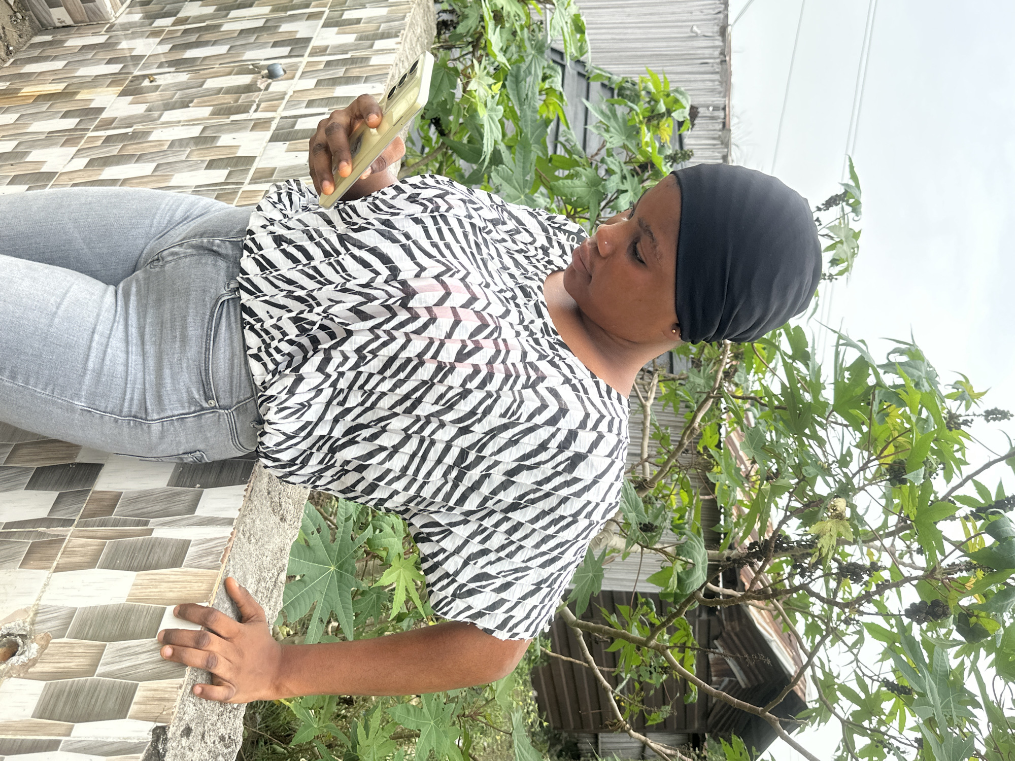 Woman documented using smartphone outdoors in Badagry, Nigeria
