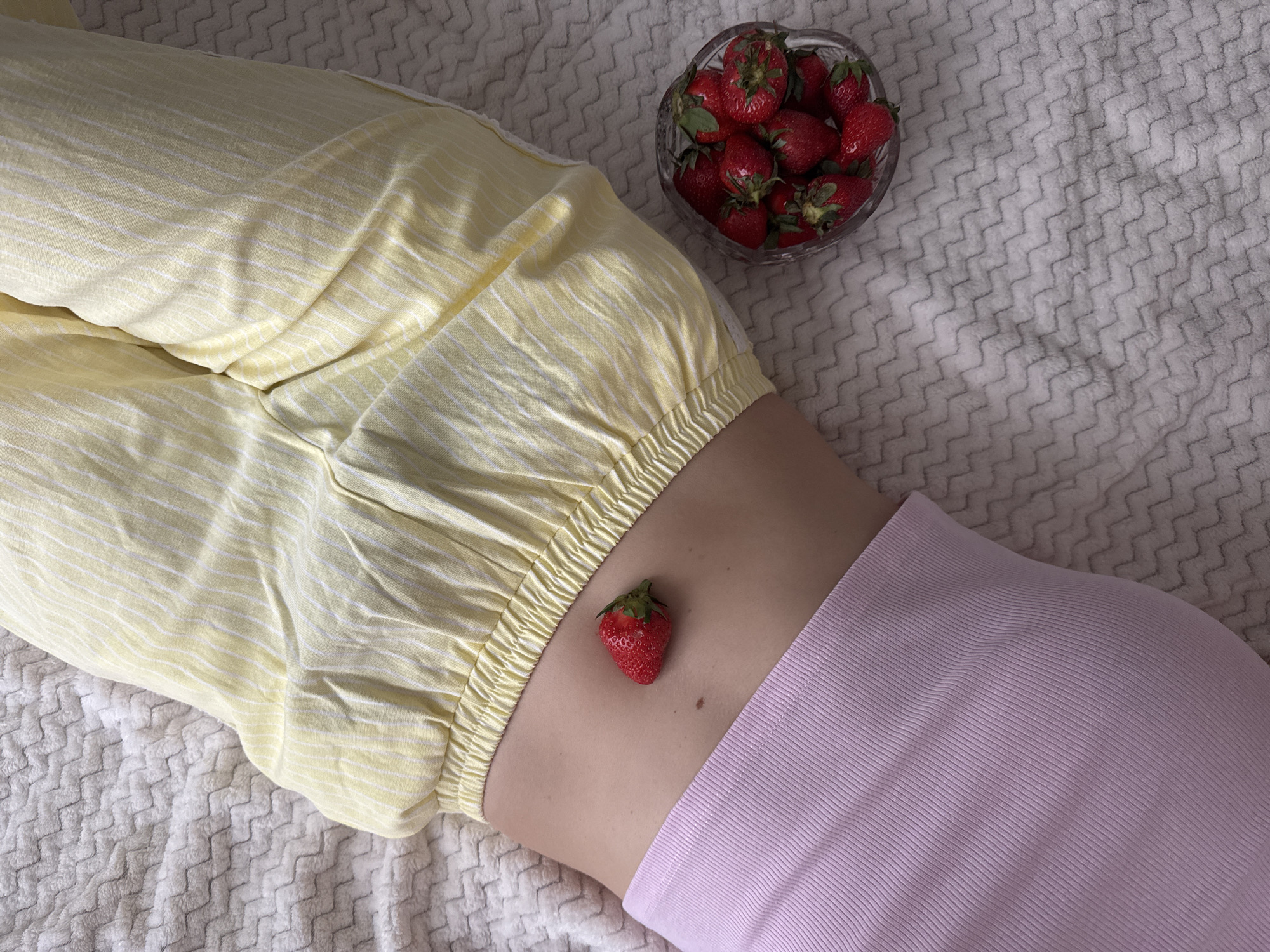 Person enjoys outdoor reading session with strawberries in Izhevsk