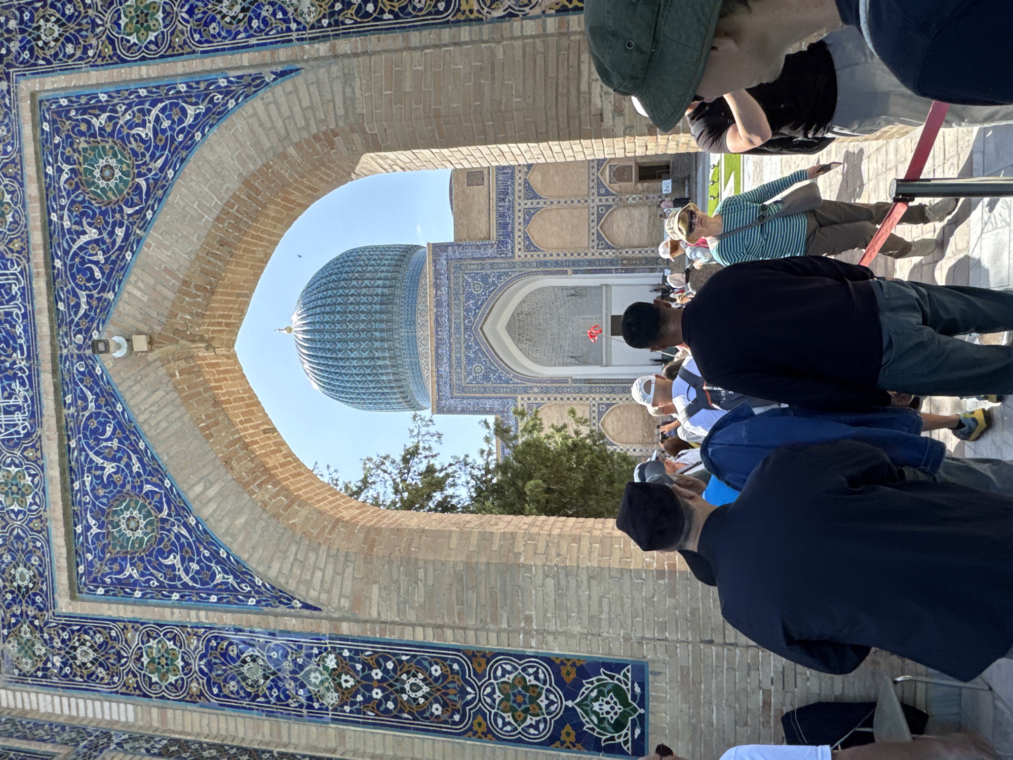 Tourists photograph historic Gur-e-Amir mausoleum in Samarkand