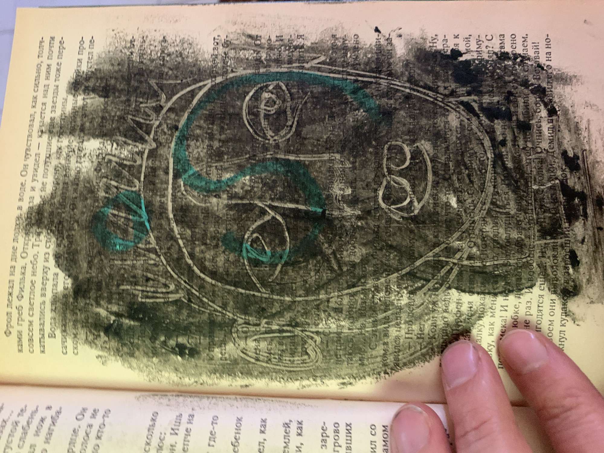 Russian book pages defaced with drawings, charcoal, and photos