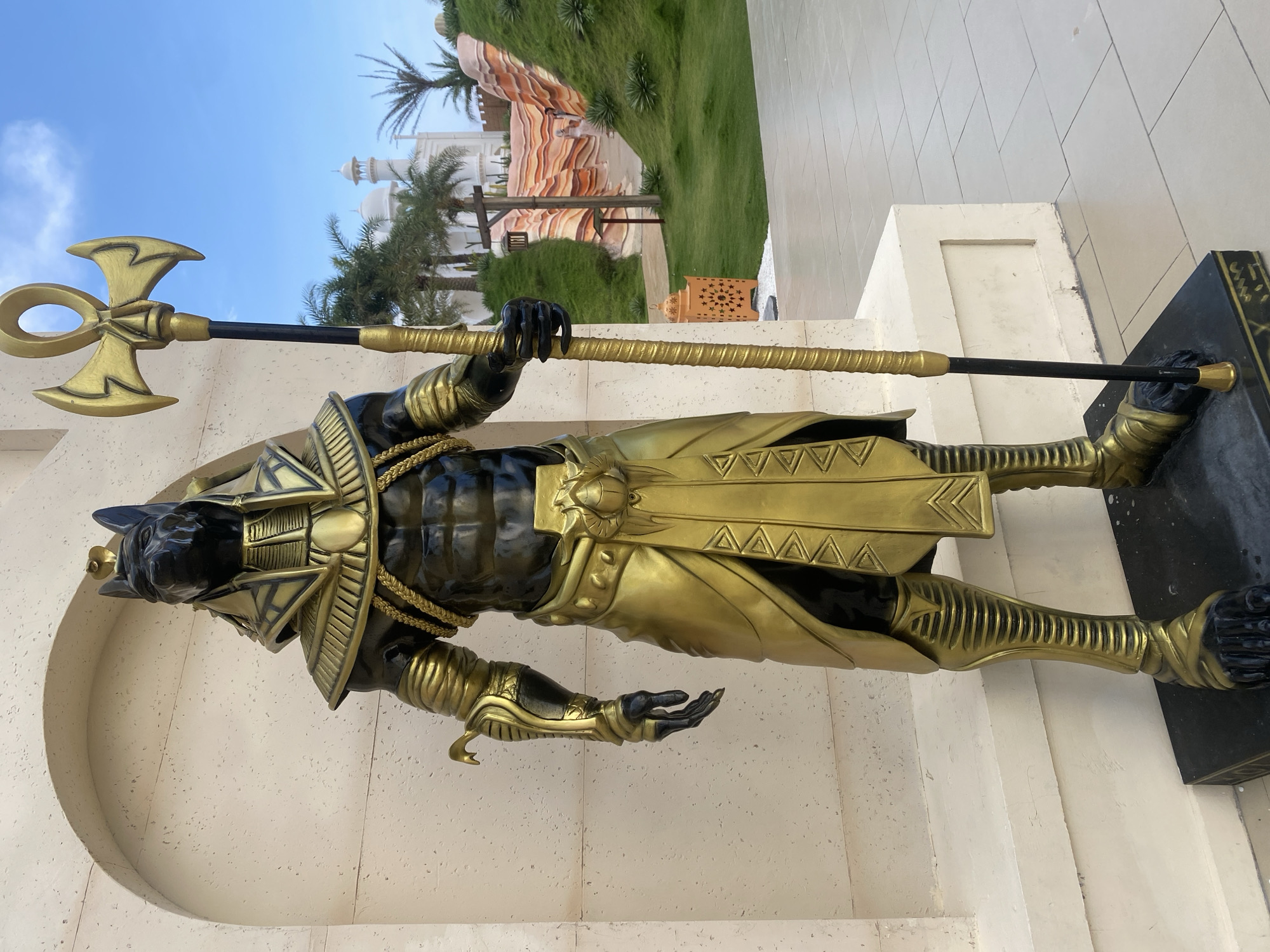 Tourist women photographed near Egyptian Anubis statue in Vietnam