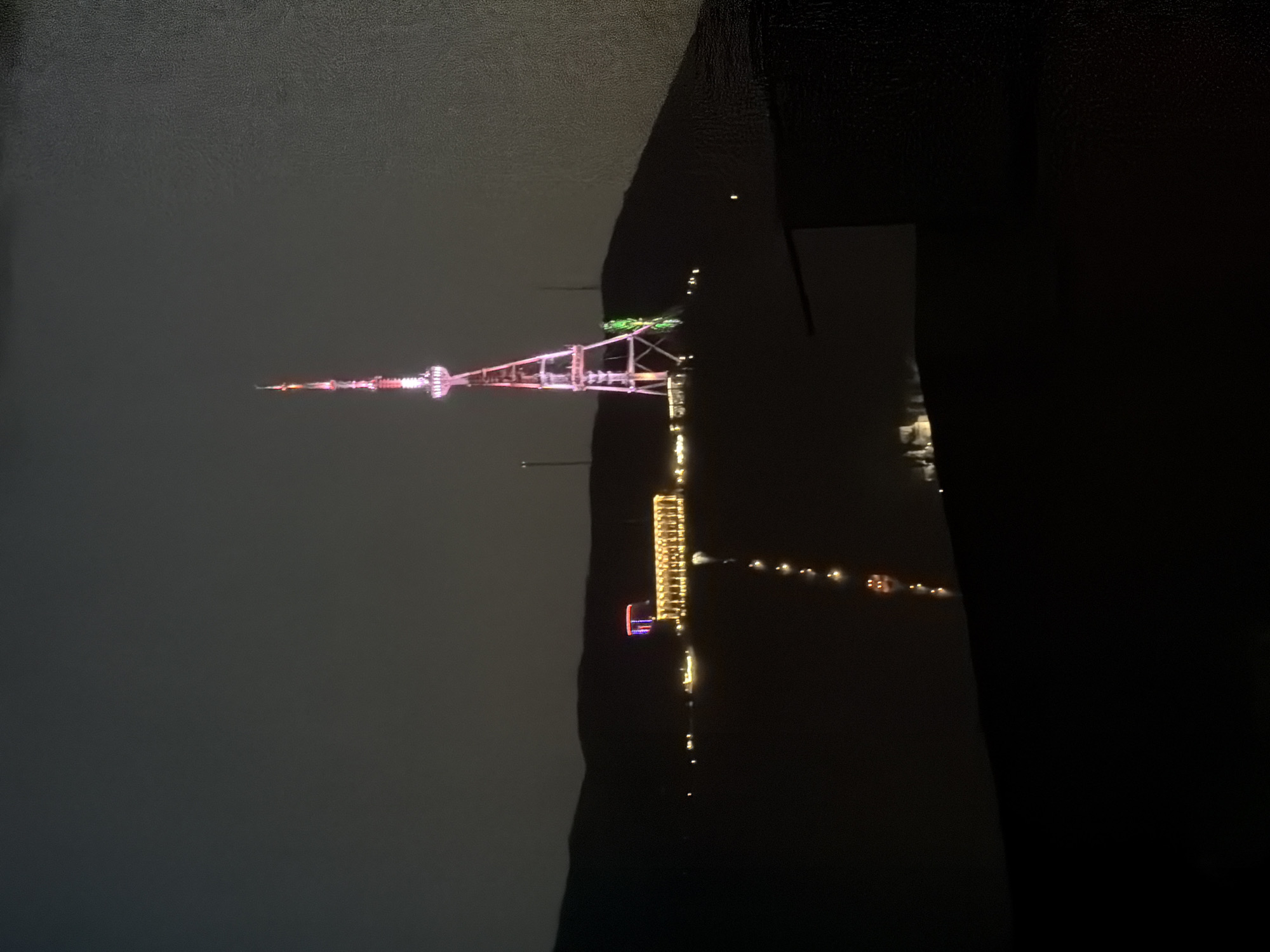 Tbilisi TV Tower displays pink and white lighting at night