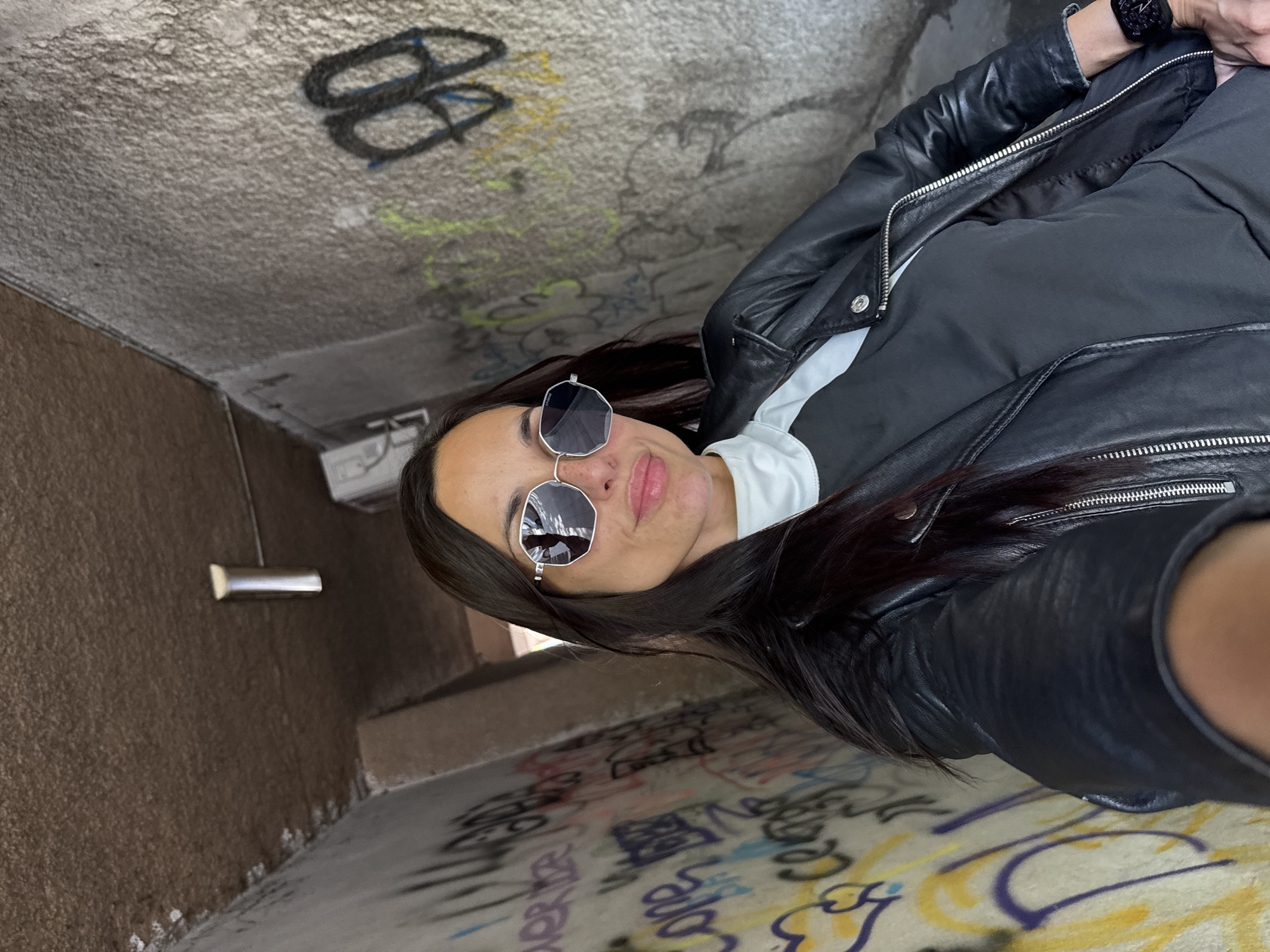 Woman takes selfie in graffiti-covered tunnel in Pleven, Bulgaria