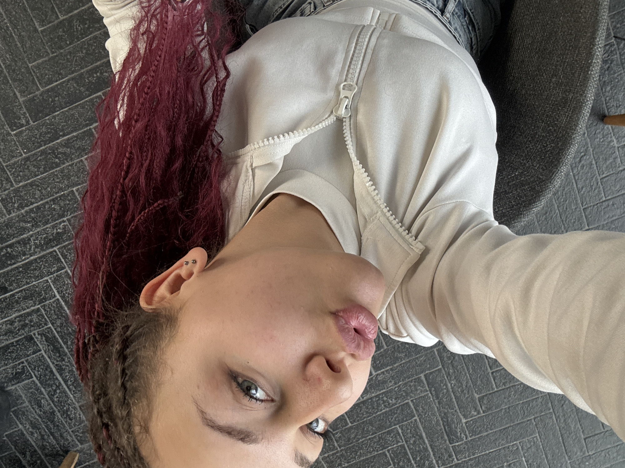 Person with braided hair seated indoors in Varna