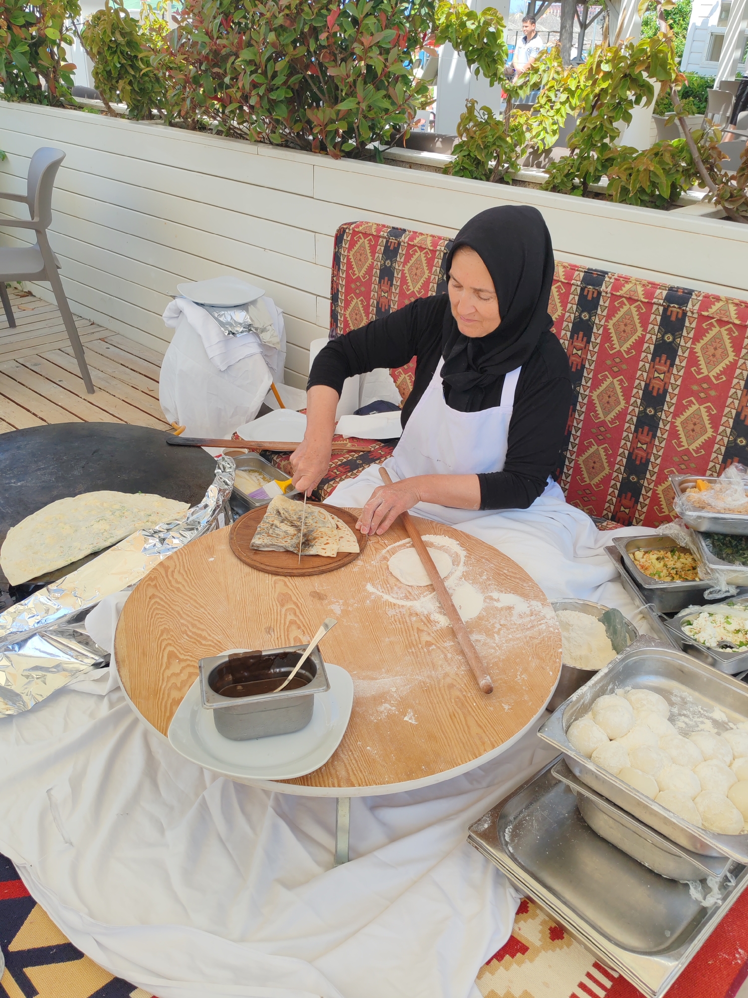 Woman prepares traditional food at outdoor station in Alanya