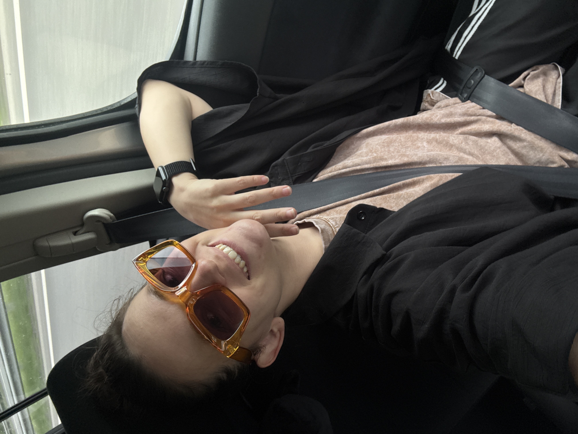 Person in orange sunglasses observed traveling by car in Shali