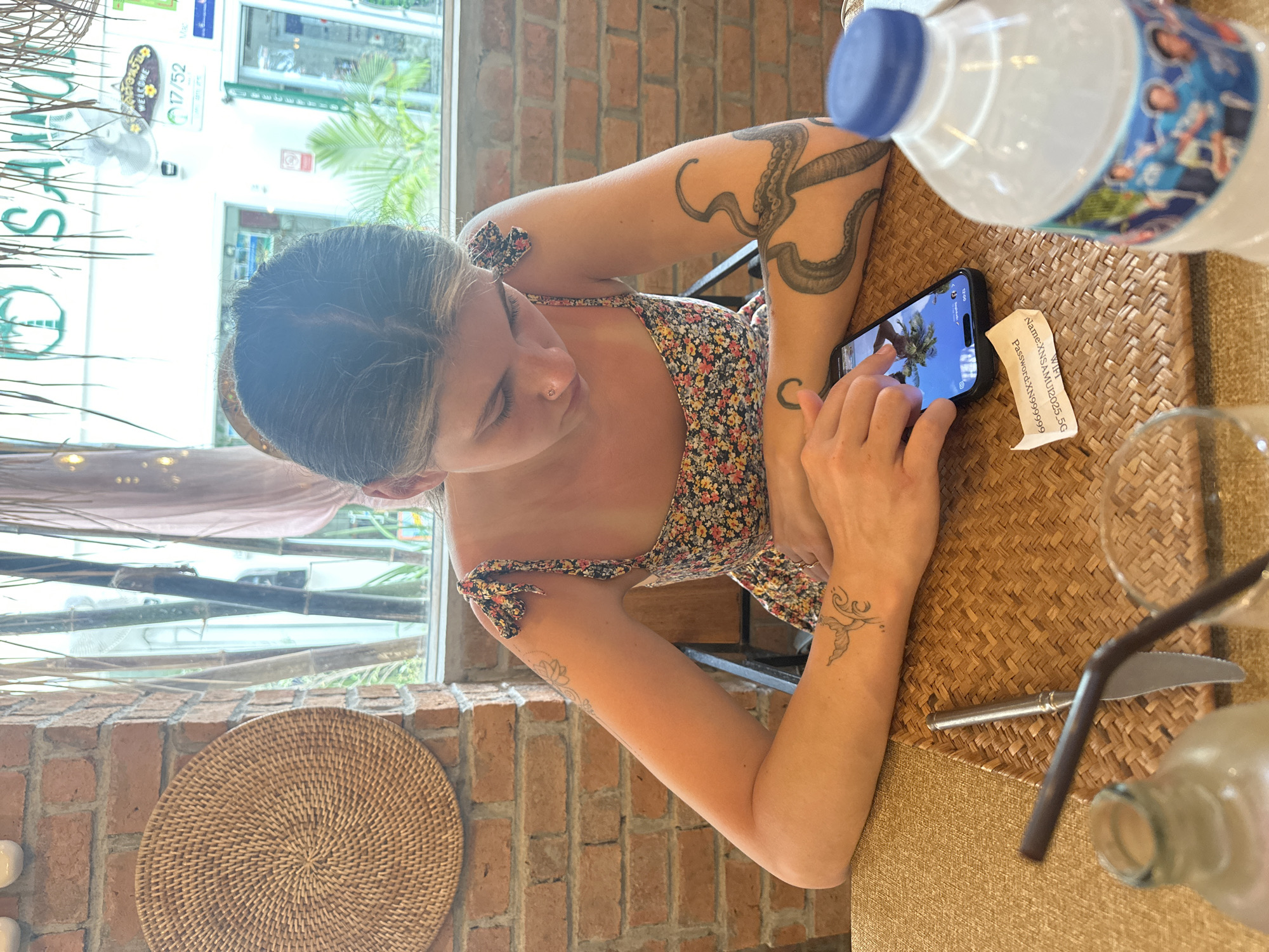 Woman dines alone at early morning cafe in Thailand