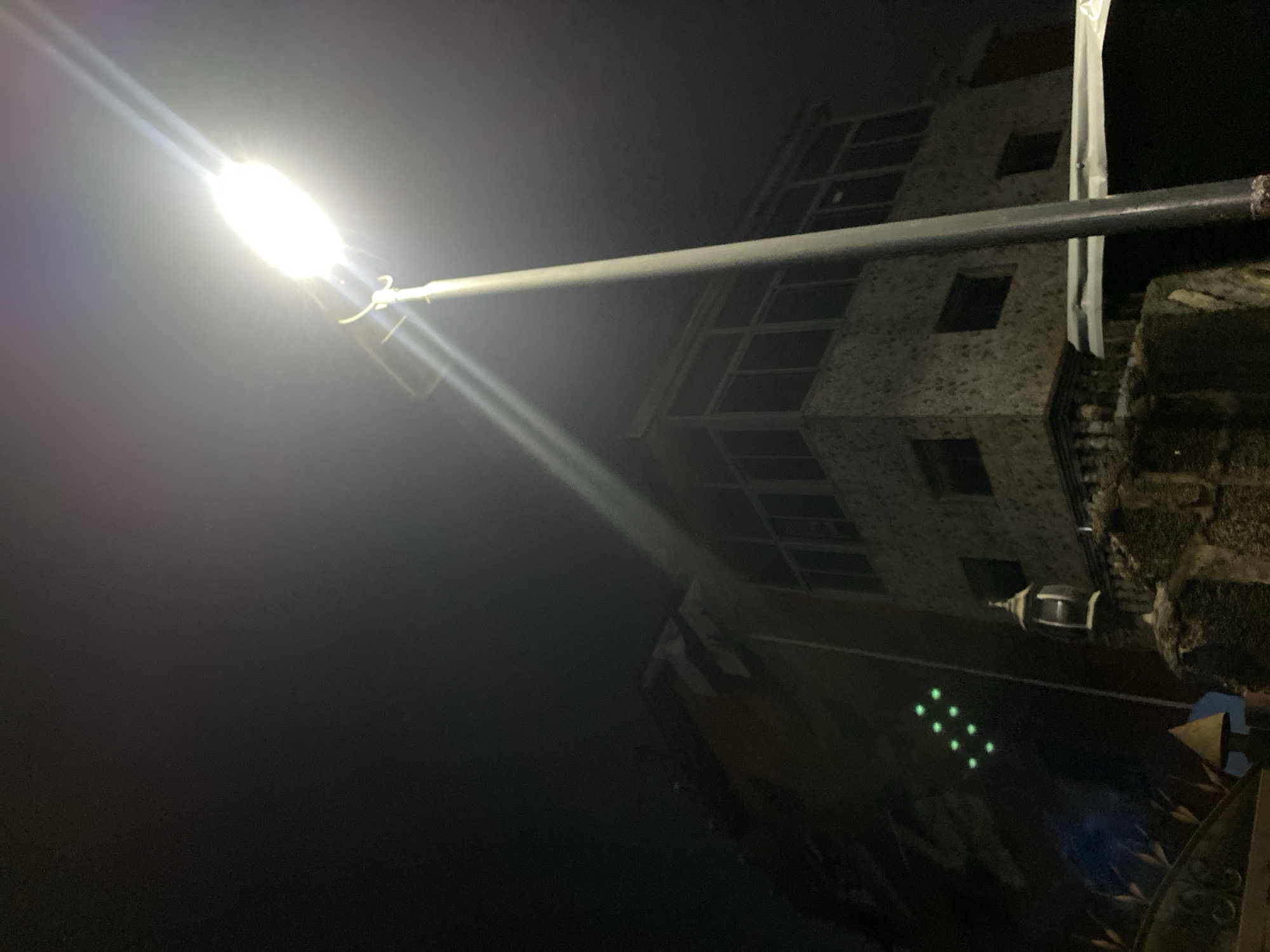 Street lamp illuminates building in Lagos at night