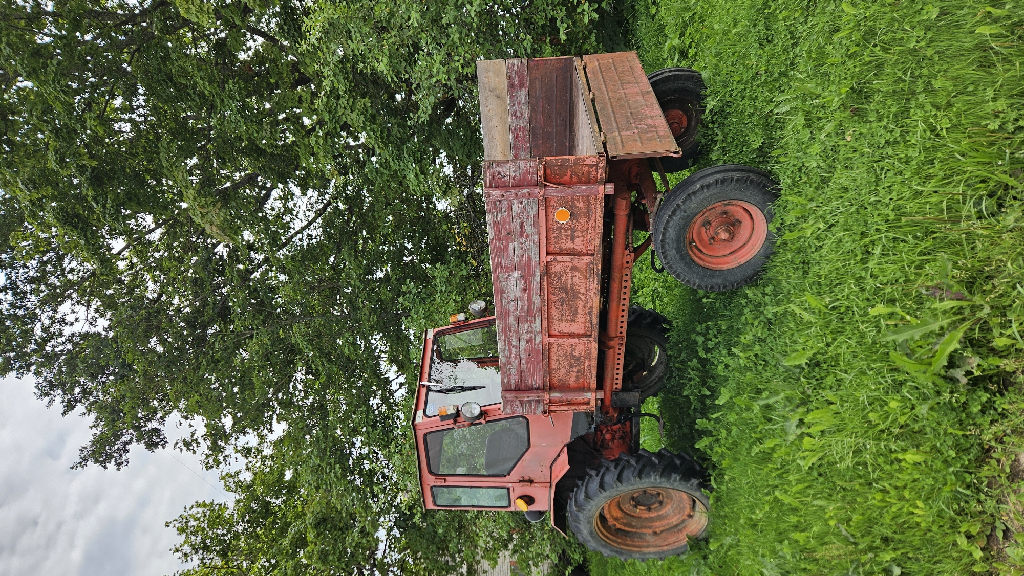 Tractors and apple trees on a Latvian farm morning