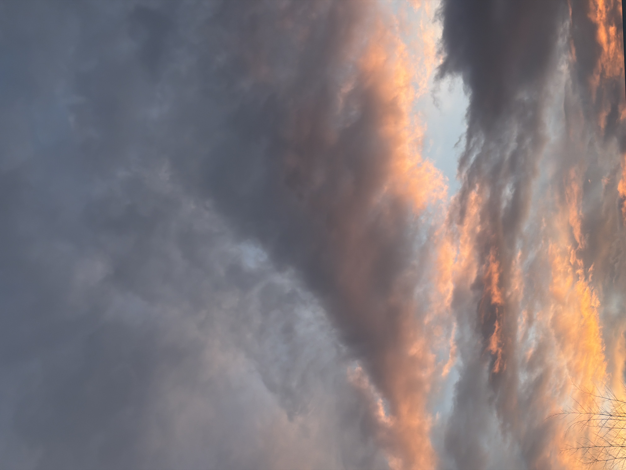 Aircraft flies through dramatic sunset skies over New Westminster