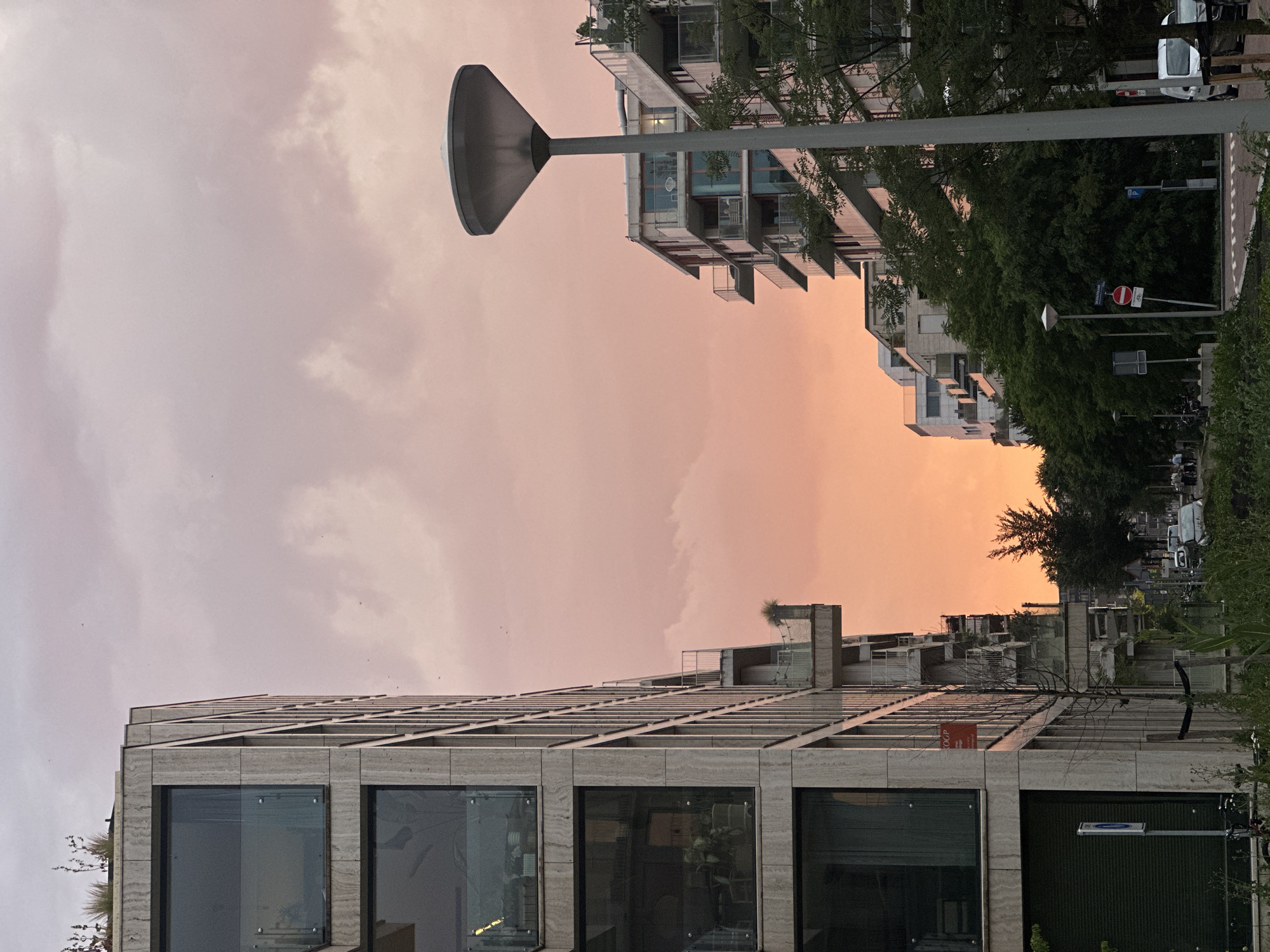 Amsterdam residential streets at dusk, modern architecture under a pink sky