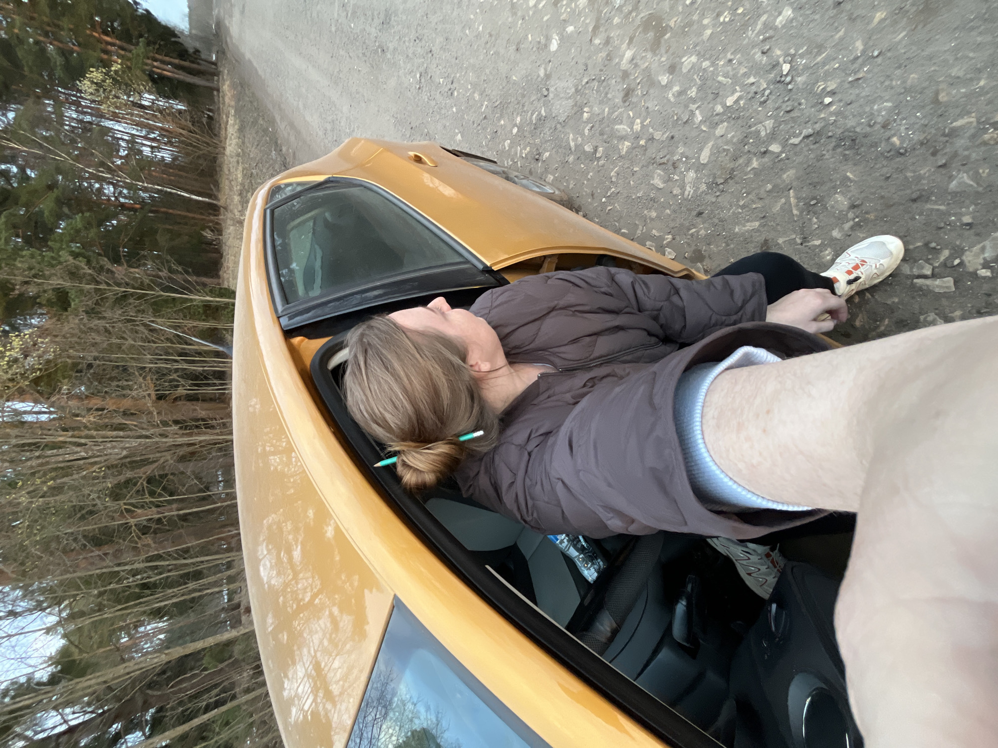 Woman rests in parked car along Russian roadside