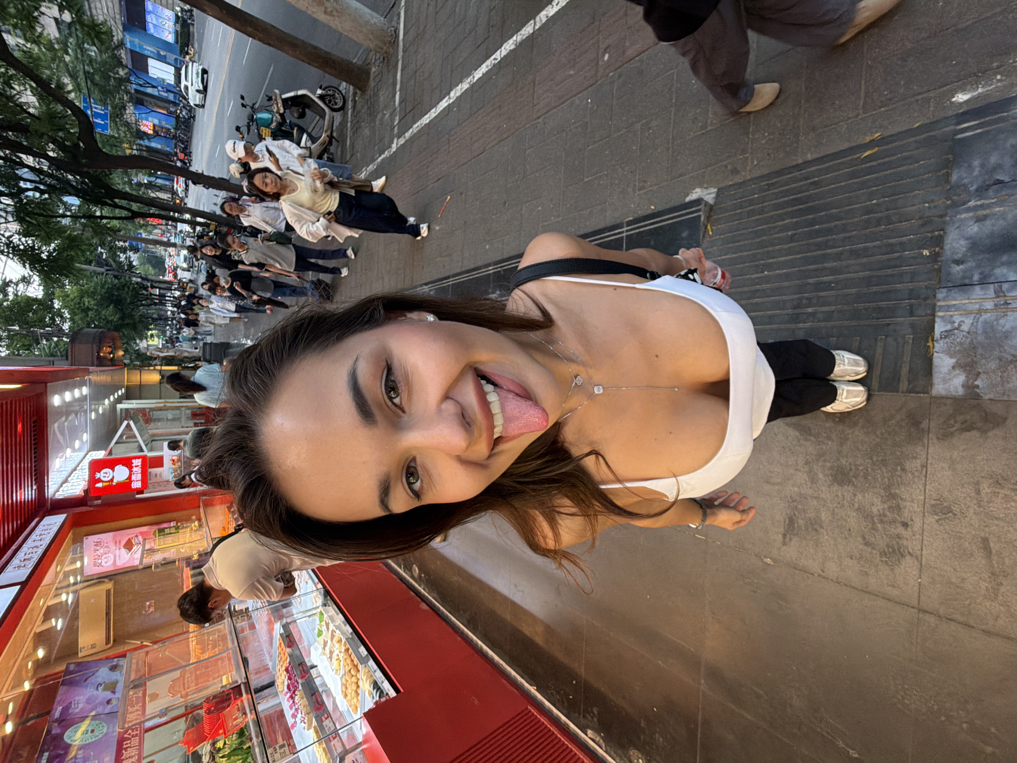 Woman takes playful selfies on busy Shanghai street