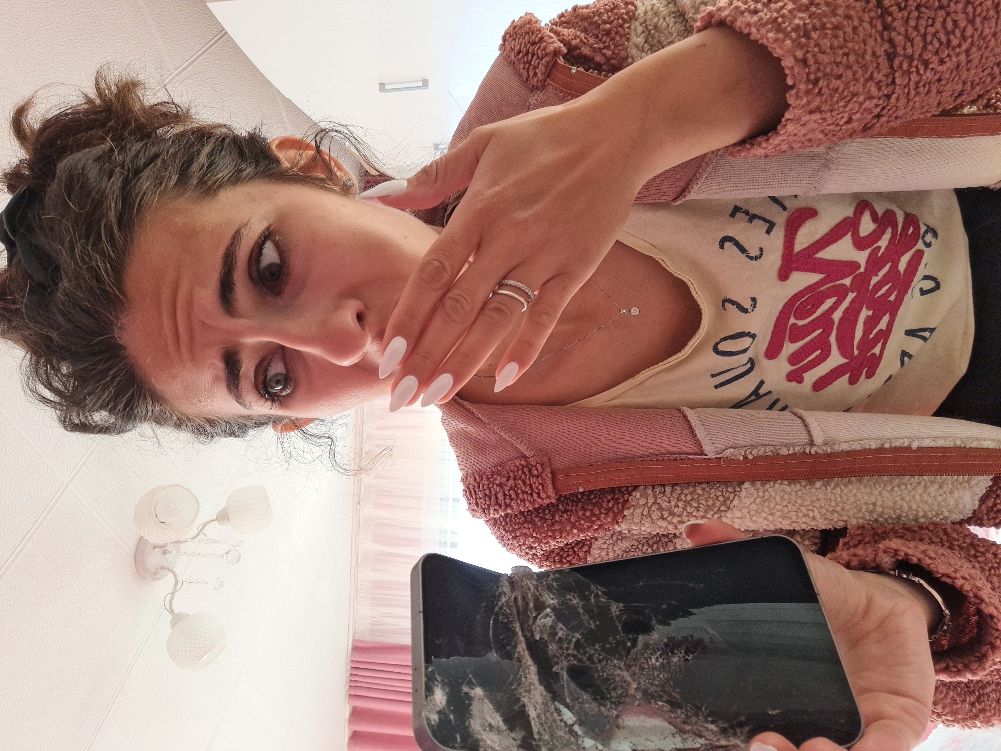 Woman deals with cracked phone, replacement in Bulgarian village