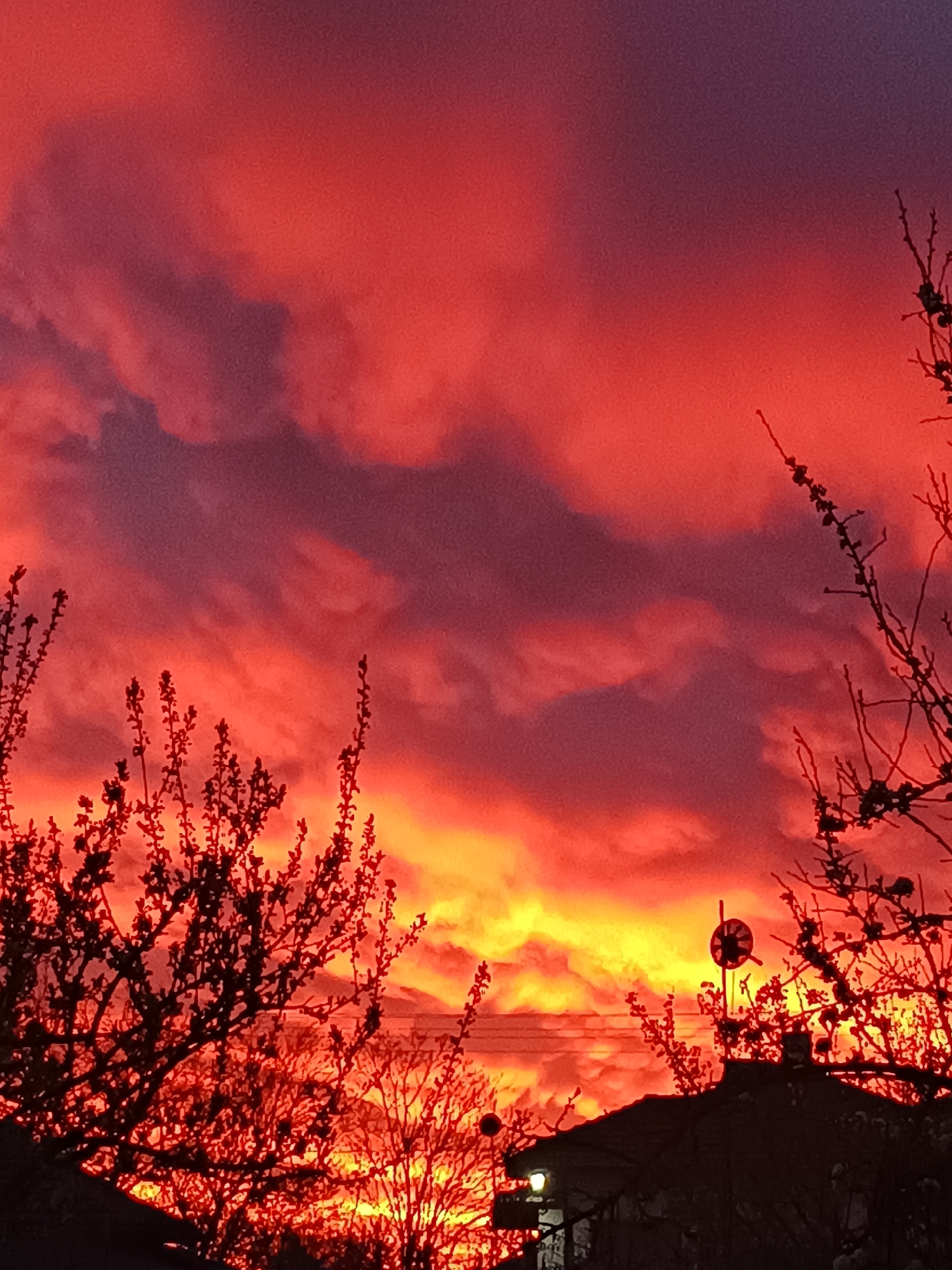 Vibrant sunset displays red-orange gradient over Bulgarian town