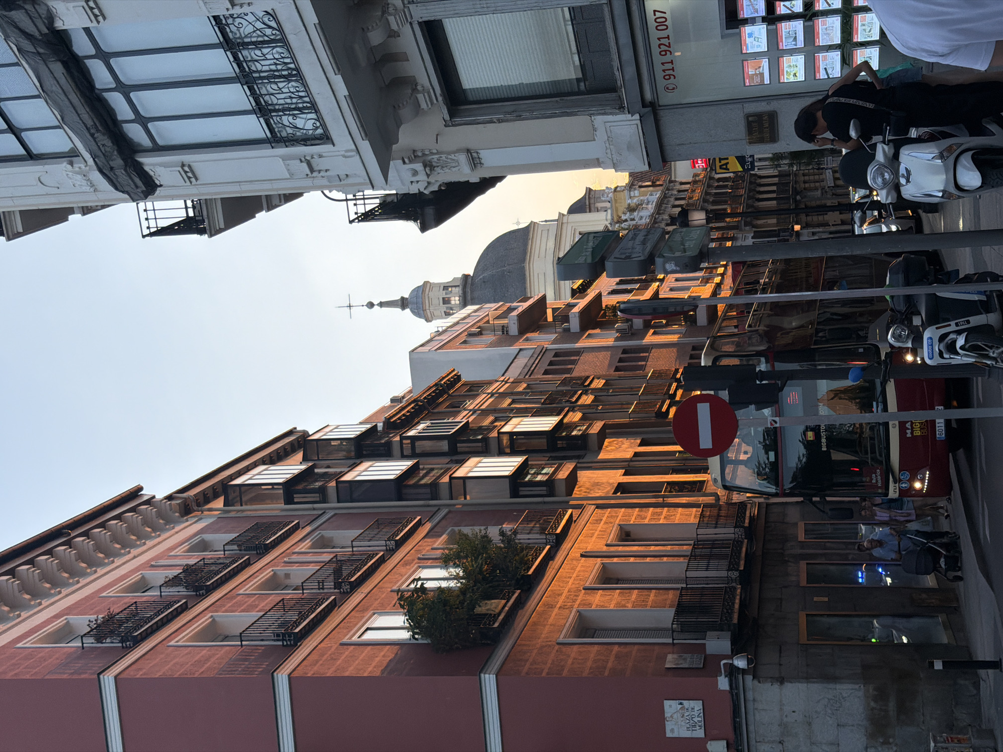 Madrid street scene glows under a summer evening sun