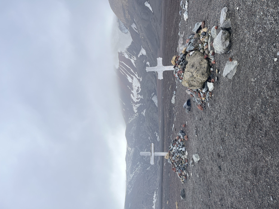Antarctic base decay documented amid overcast mountain landscape