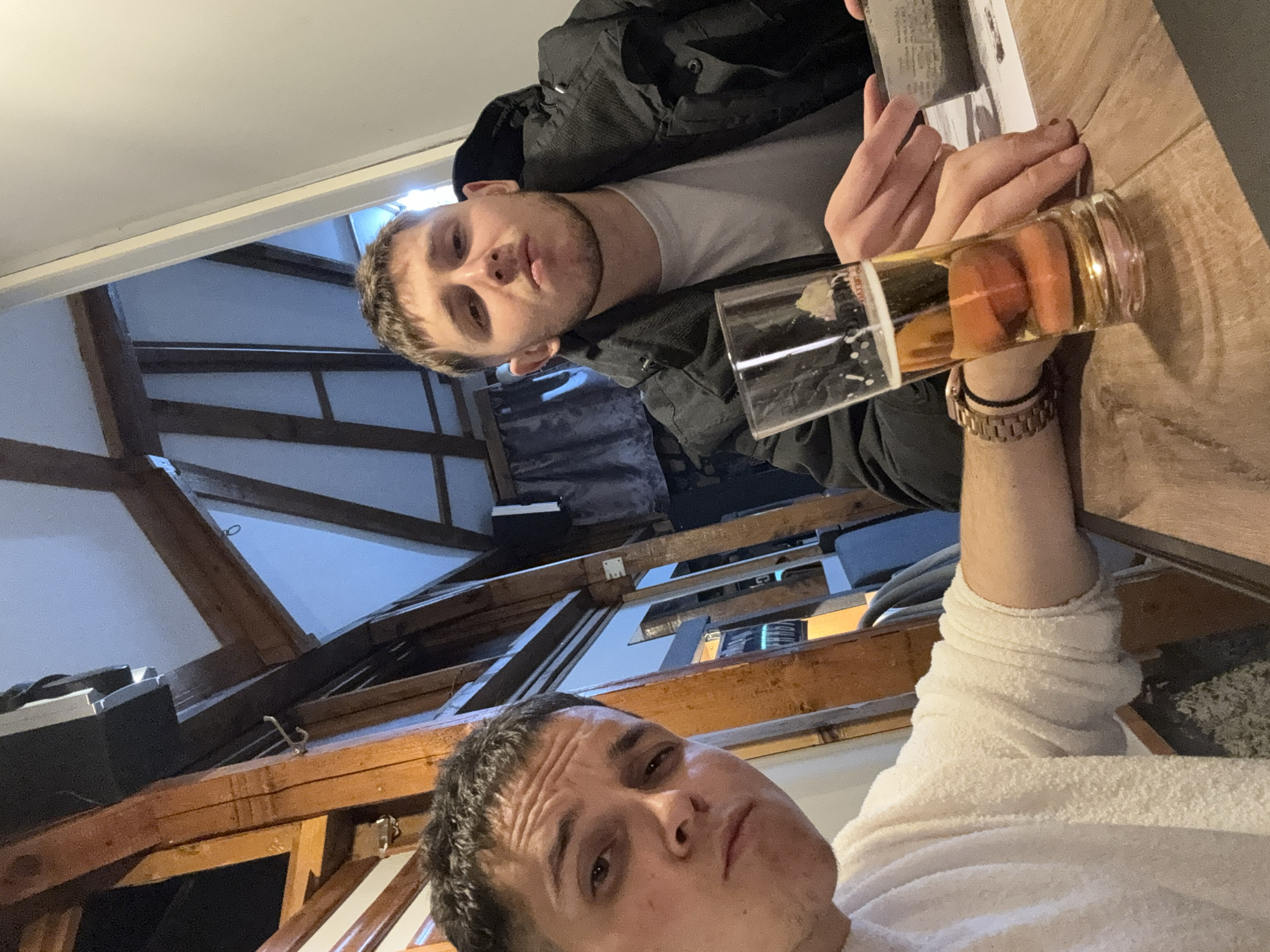 Two men share beers at Kostinbrod bar gathering