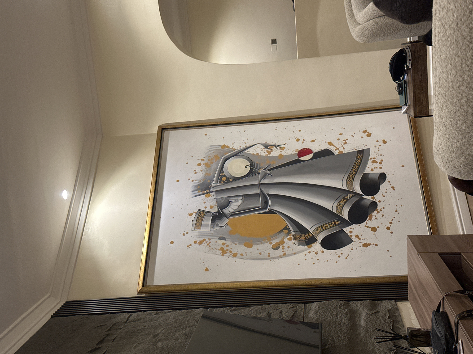 Framed artwork with gold accents observed on yellow wall