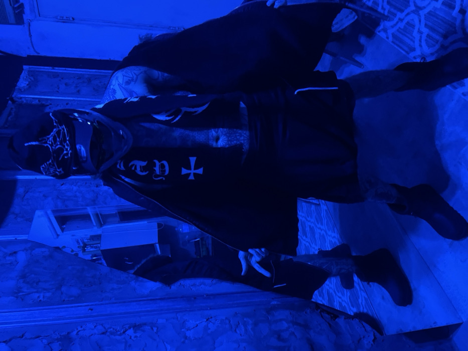 Masked individual spotted in blue-lit Buenos Aires room