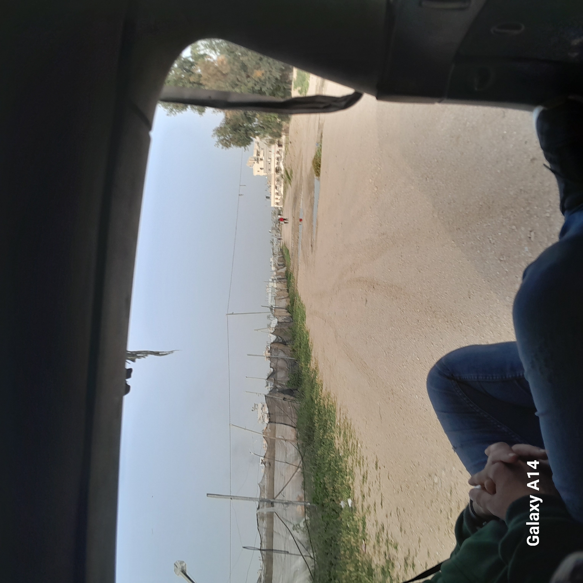Vehicle passenger photographs street scene in Khan Yunis