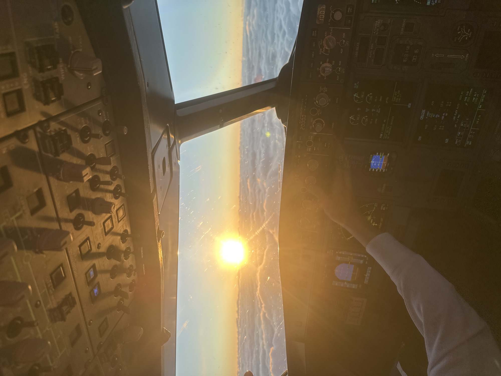 Aircraft cockpit captures sunset view over Khimki, Russia