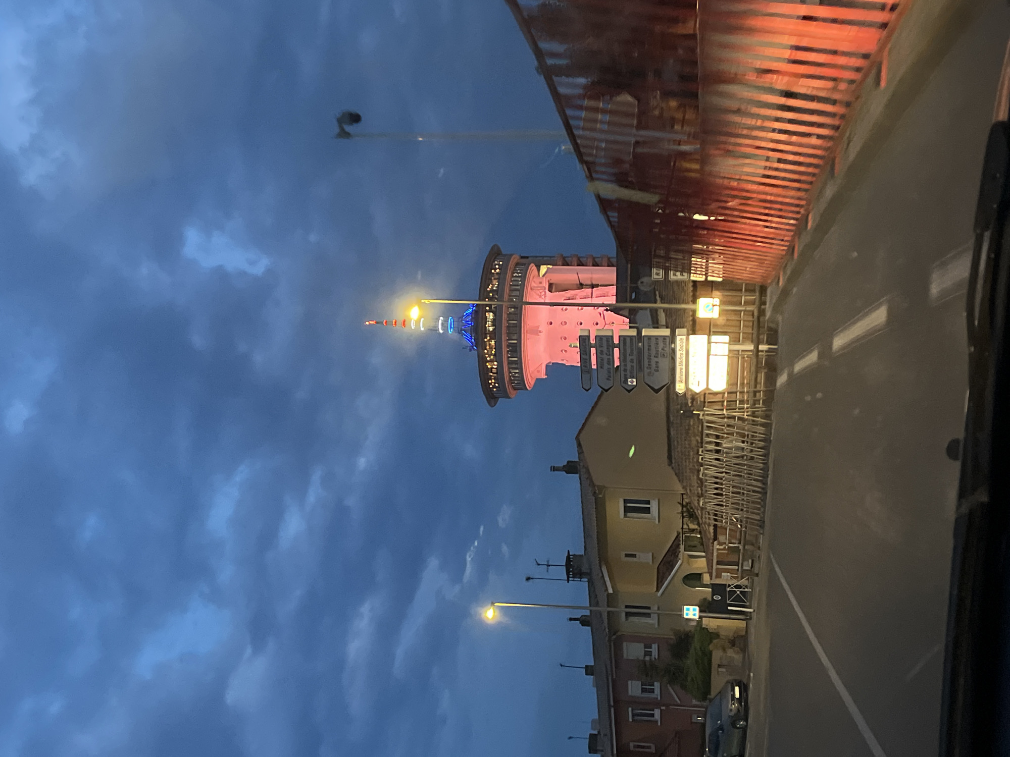 Mediterranean lighthouse illuminated against cloudy evening sky in France