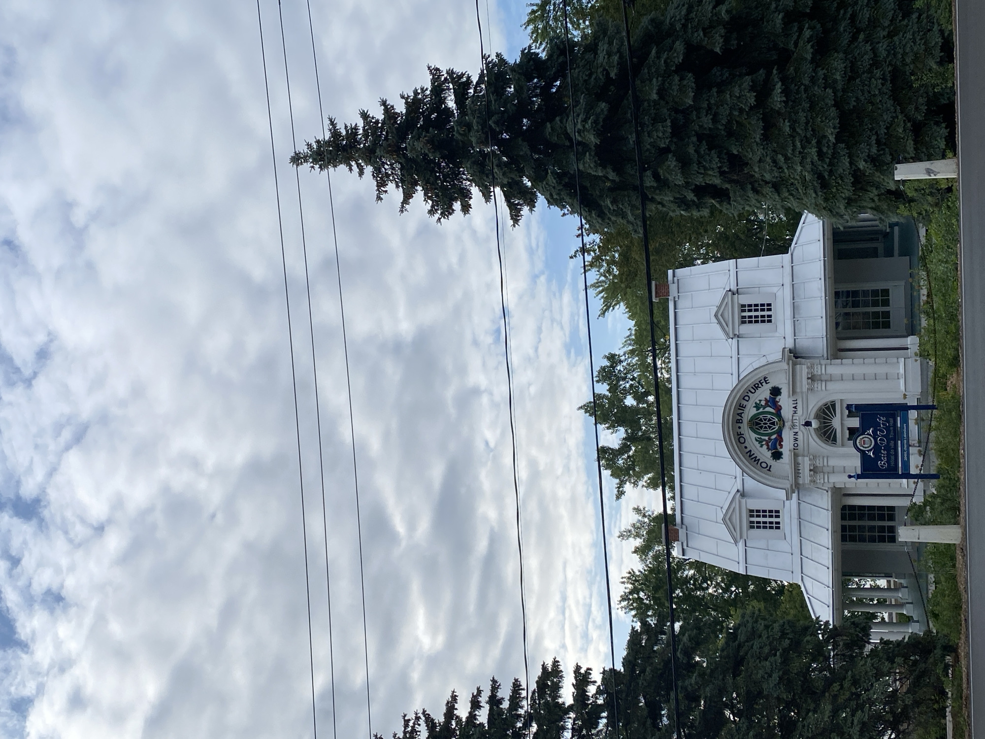 Baie-D'Urfé town hall and lakeshore under stormy skies