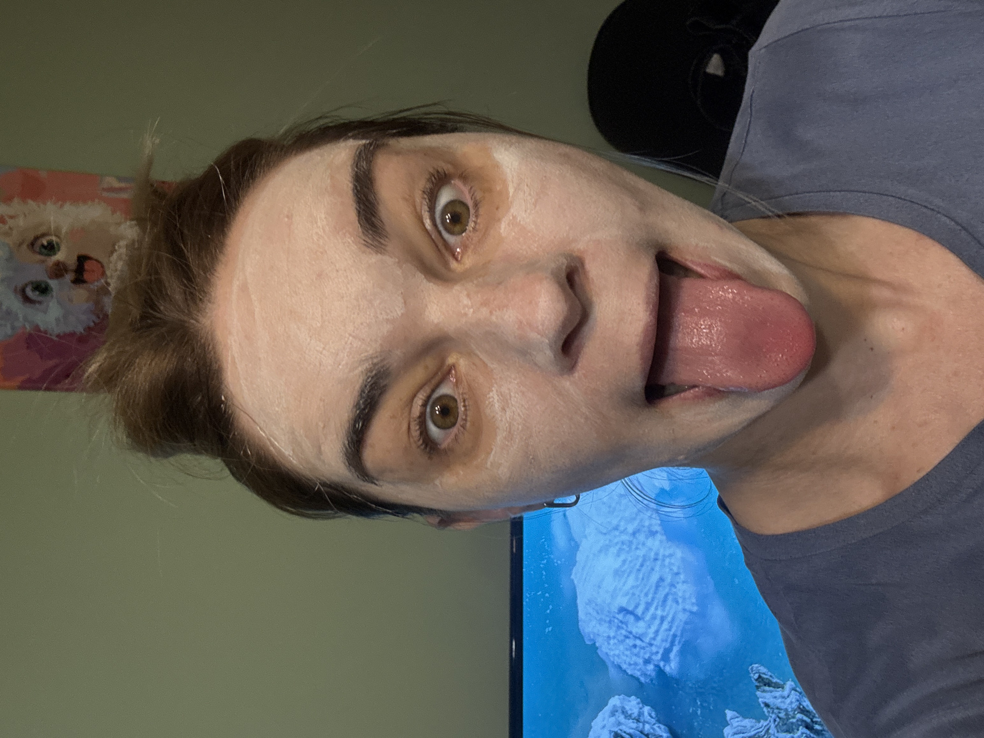 Person documents facial mask routine with white lilac flowers
