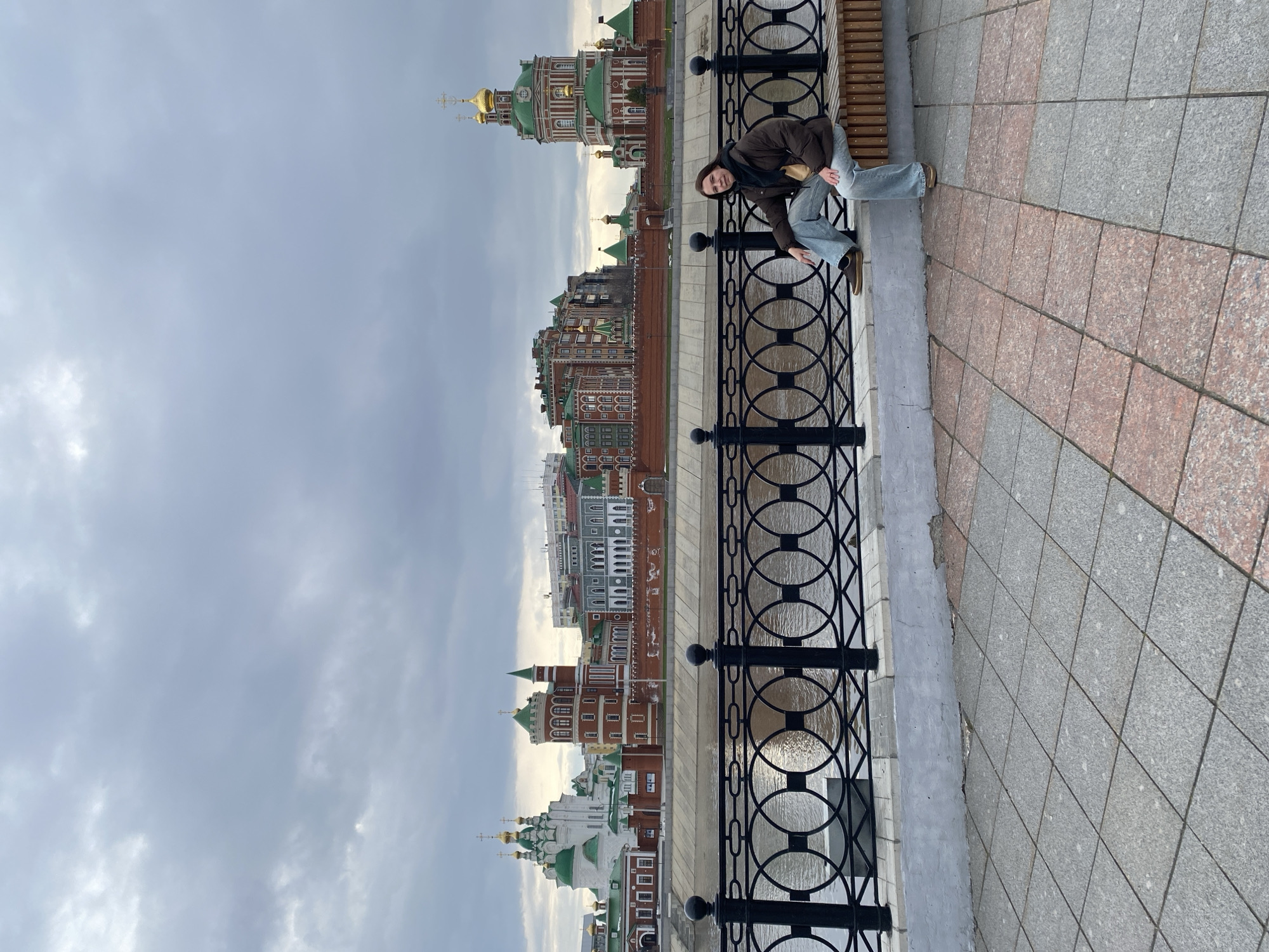 Visitors pose along Yoshkar-Ola waterfront during afternoon outing