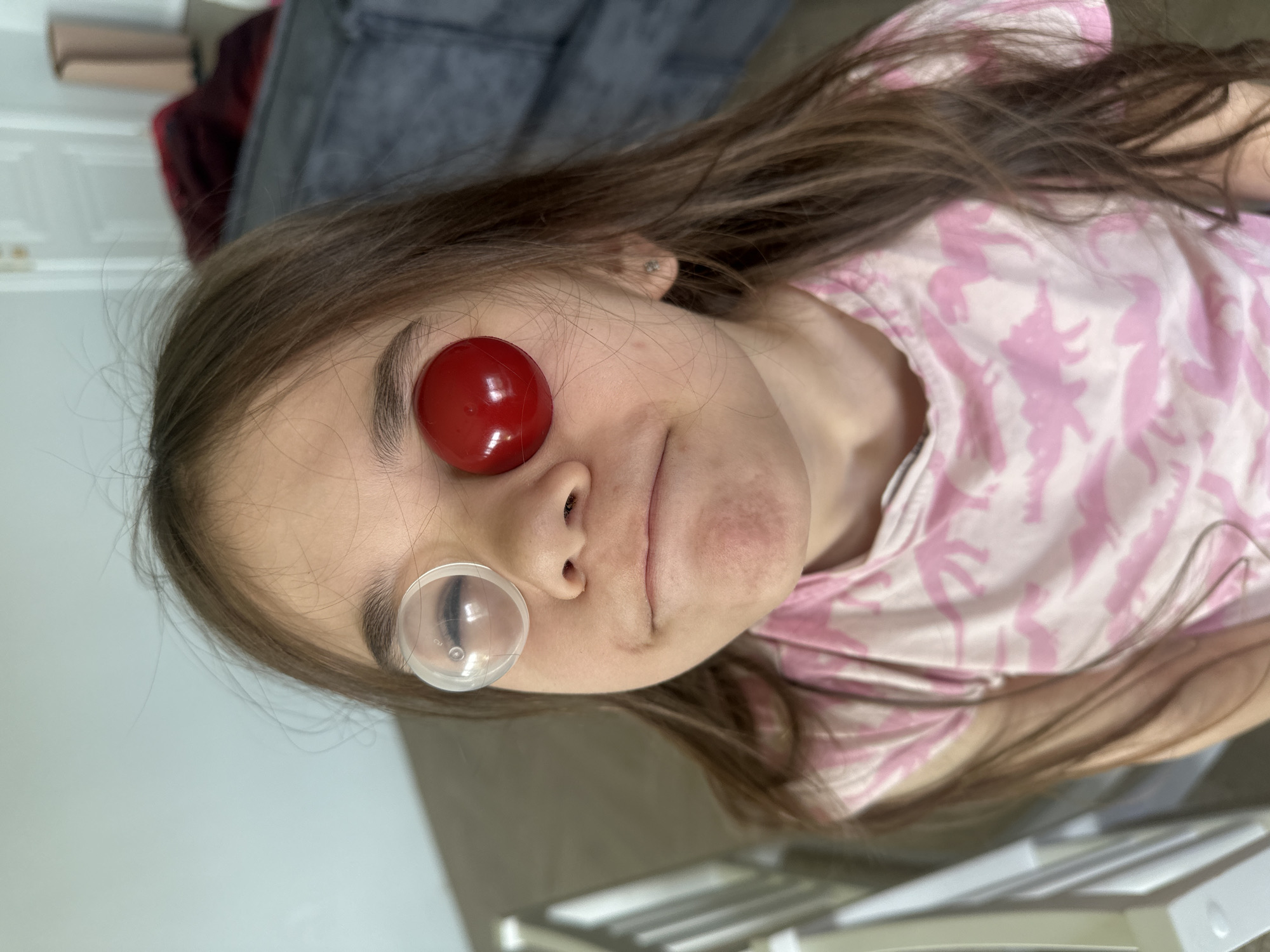 Girl photographed with red spherical object in Kharnavy, Russia