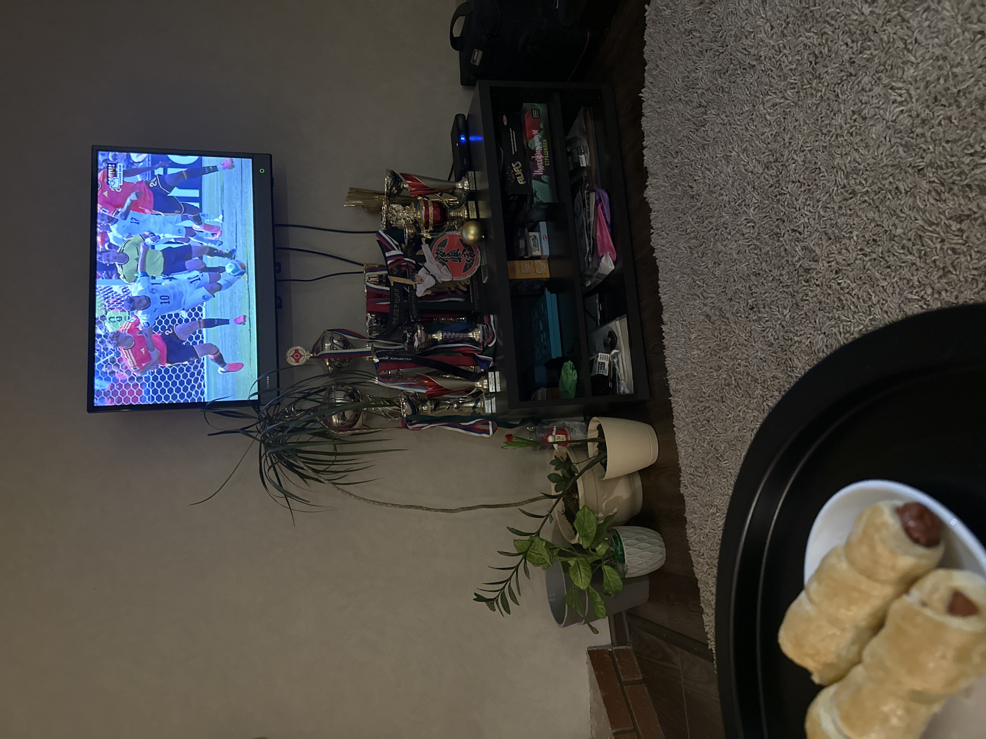 Football on TV, sushi on the table, evening in.
