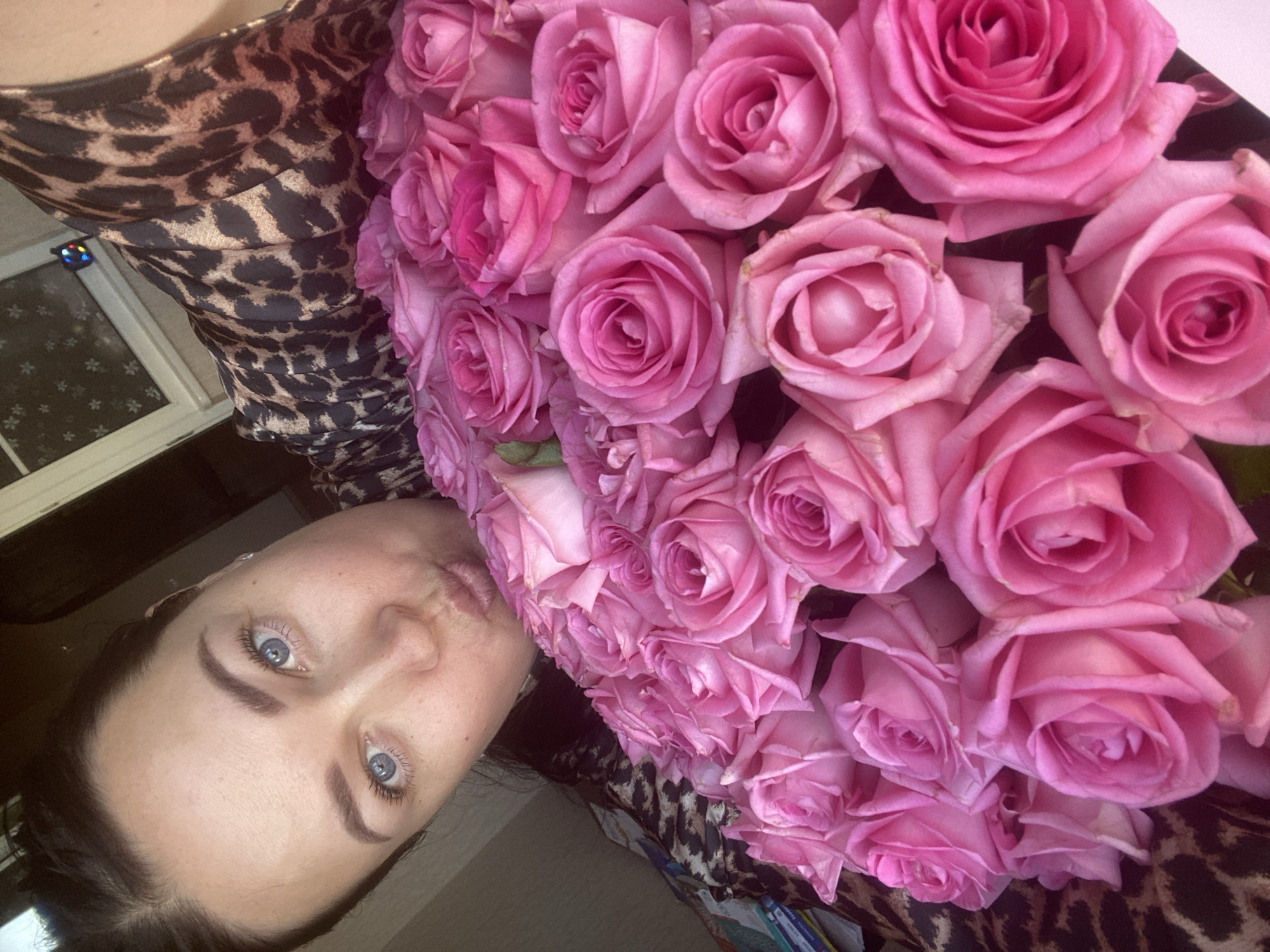 Mother and child share pink roses in Sochi home