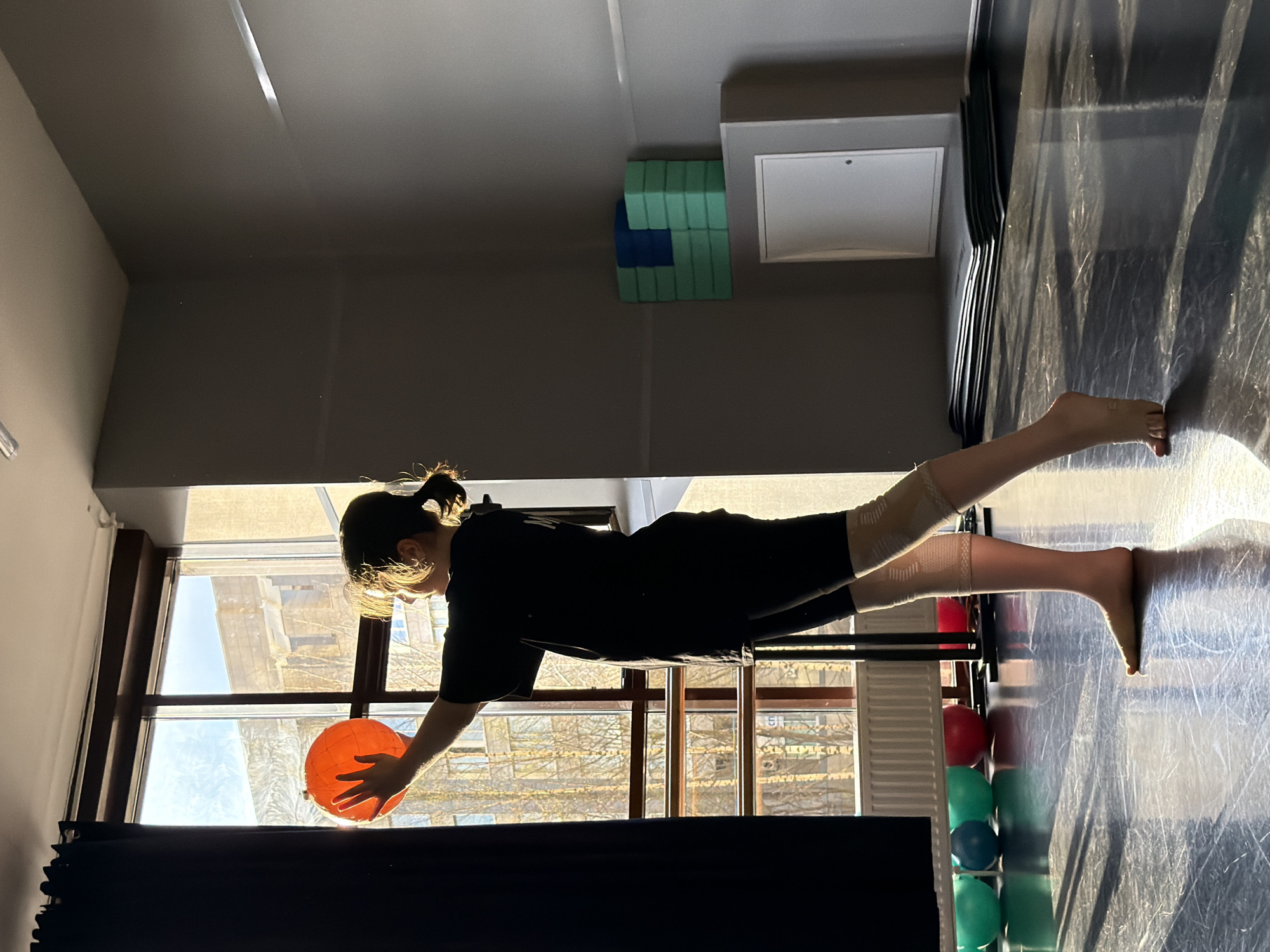 Woman exercises with orange ball in Saint Petersburg studio