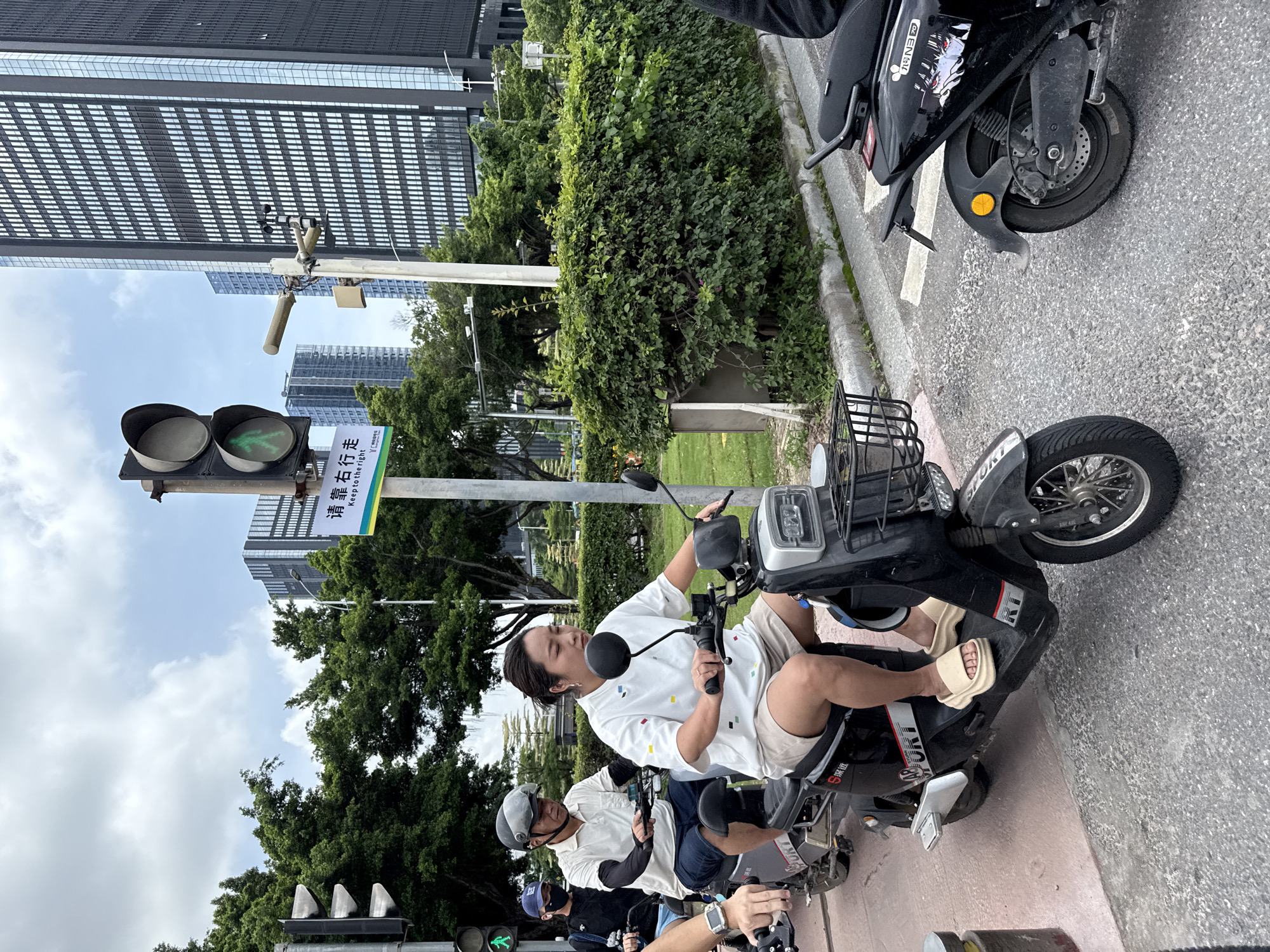 Haizhu District intersection buzzing with scooters and delivery traffic