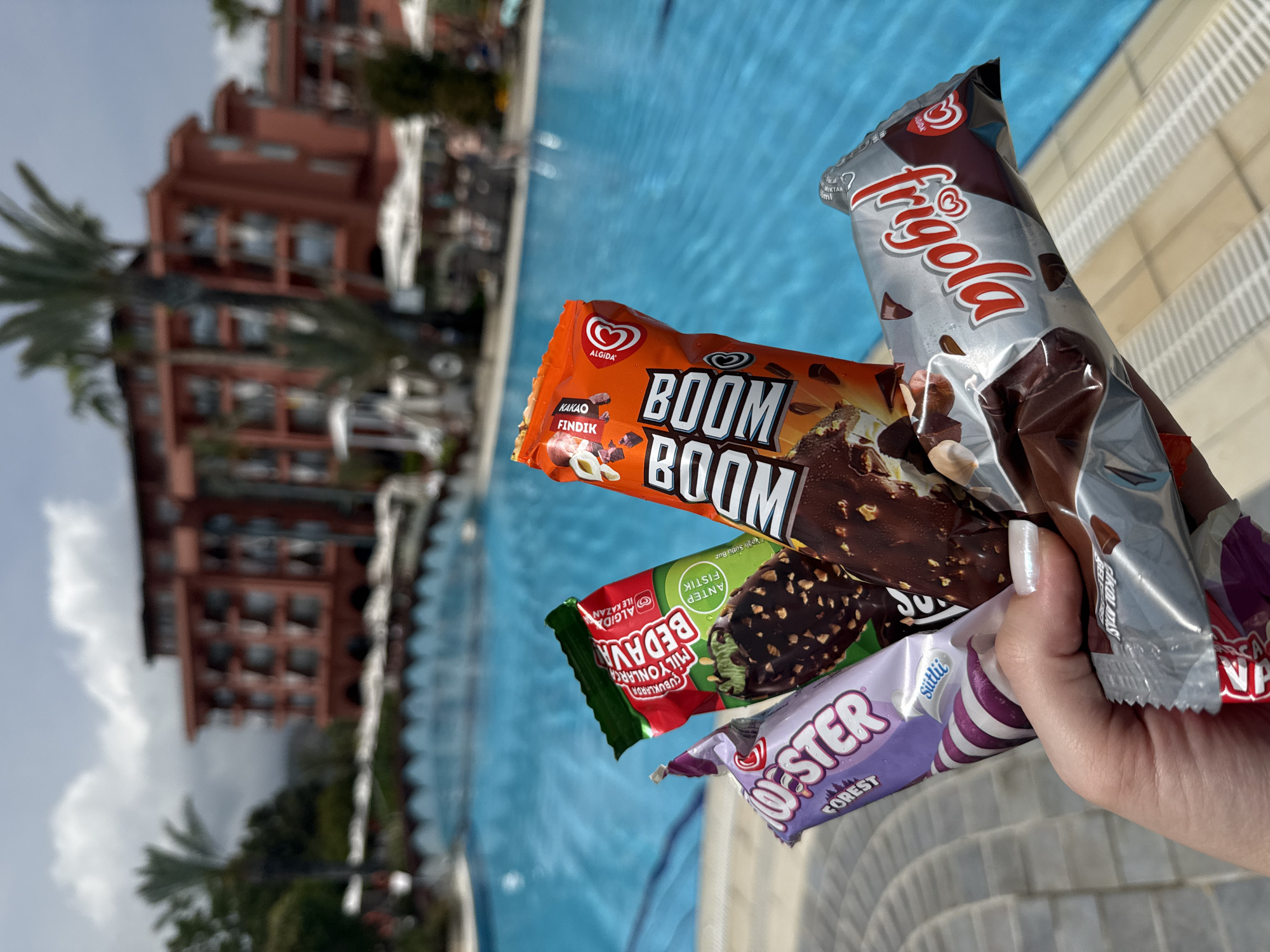 Resort guests enjoy ice cream treats by pool in Kemer