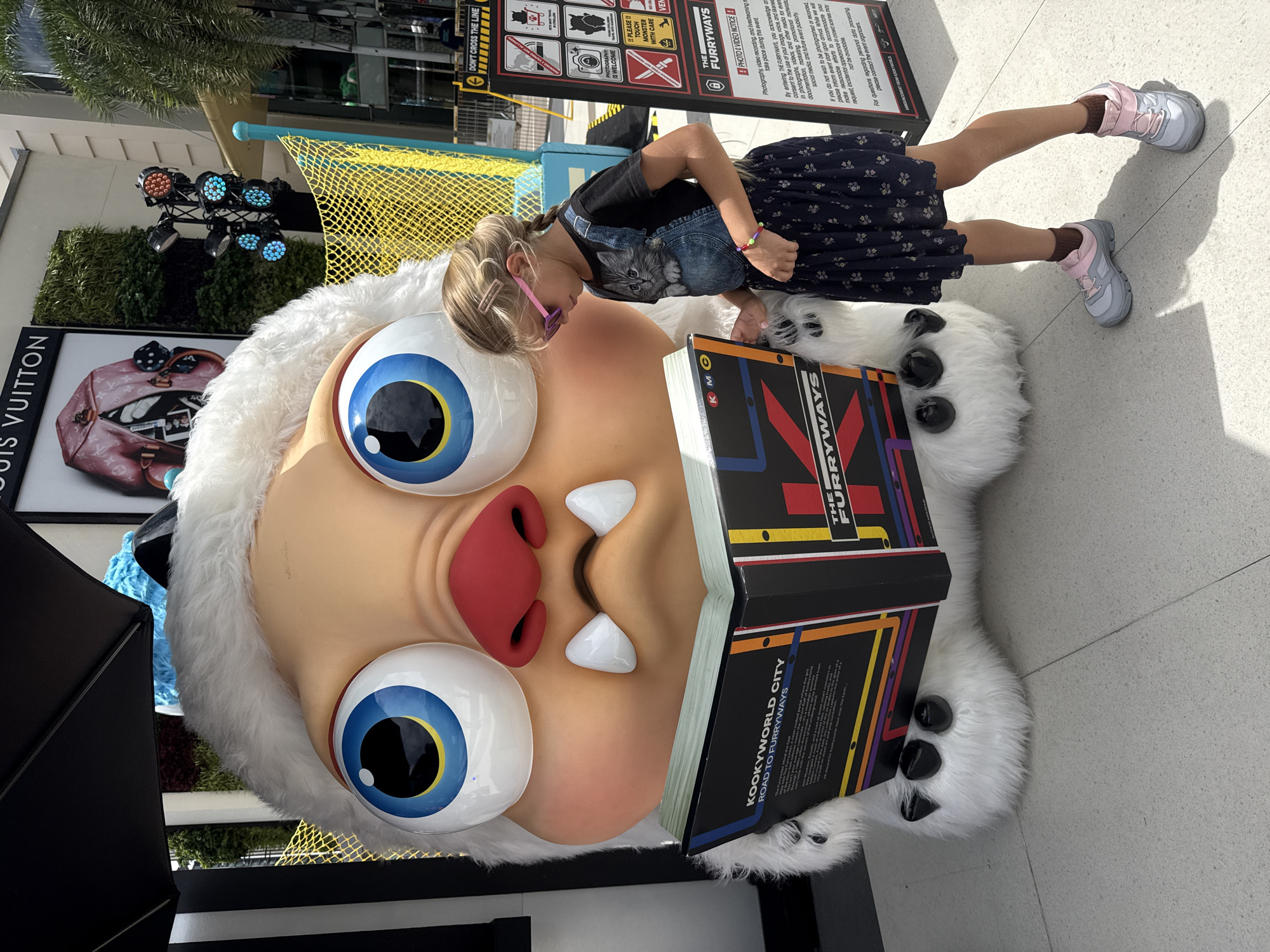 Posing with giant monster mascots at a Bangkok attraction