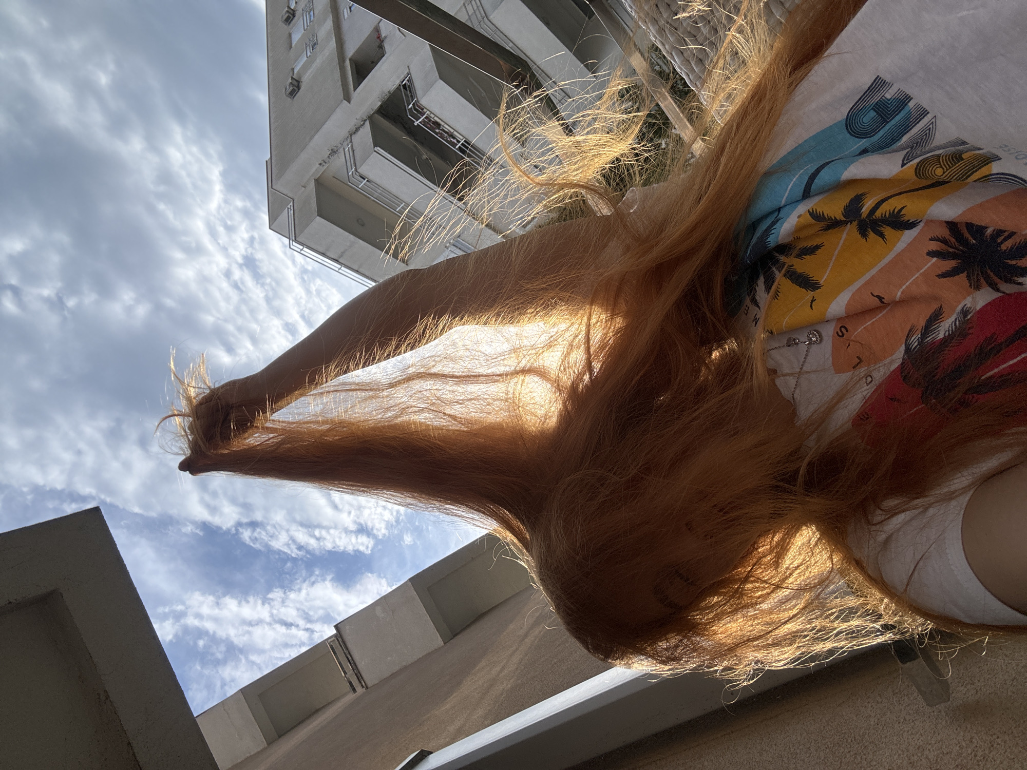Woman takes selfies on Montenegro balcony during golden hour