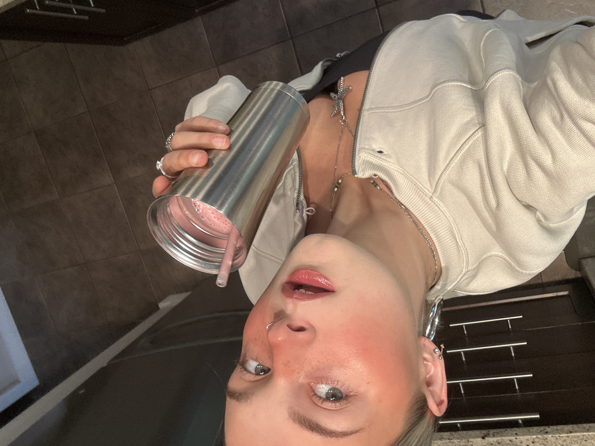 Young woman photographed with pink drink in Whistler kitchen