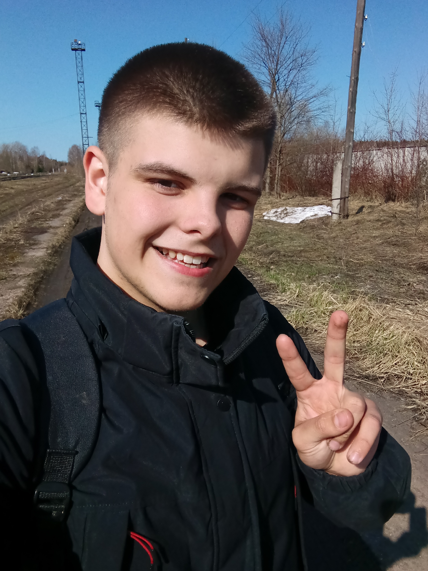Young man takes selfies at railway yard in Andreyevo